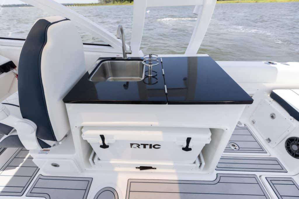 Manufacturer Provided Image: 2025 Sea Fox 268 Traveler boat interior with sink and RTIC cooler.