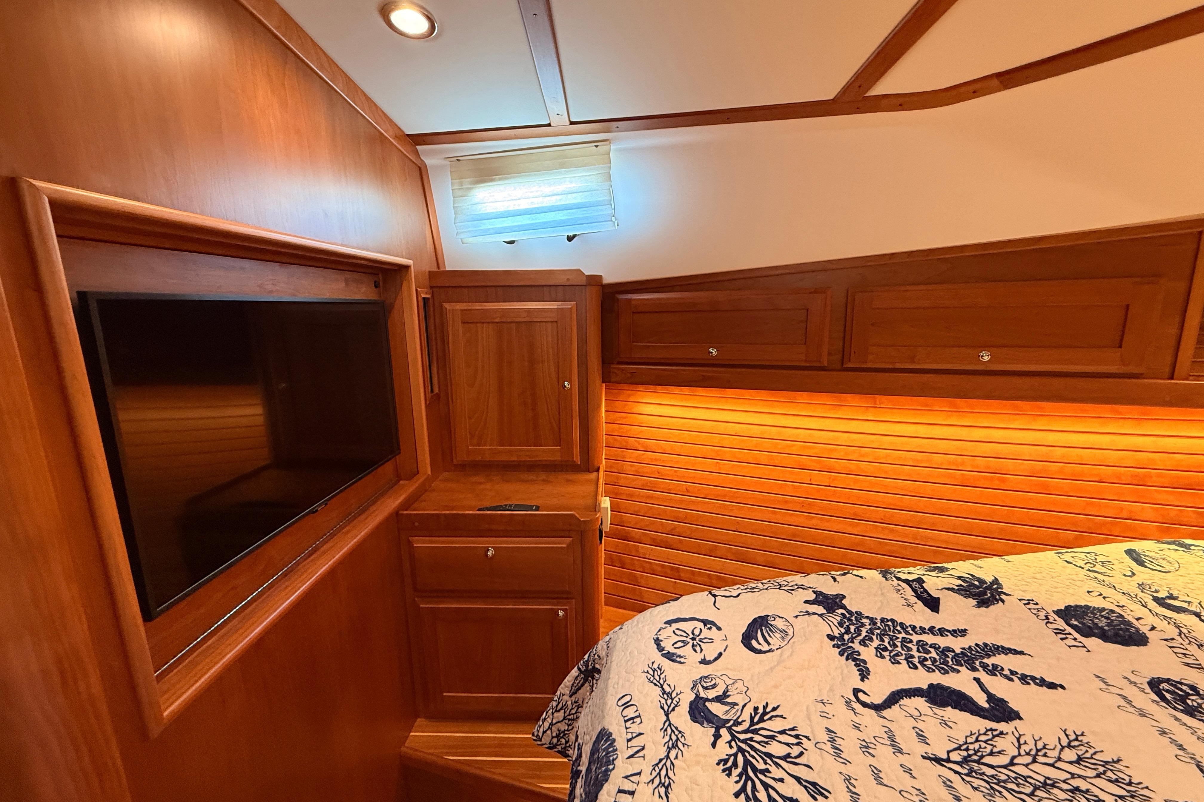 Luxurious 2022 Sabre 38 Salon Express cabin with wood paneling and built-in TV.