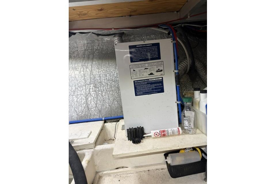 Engine room of 2007 Navigator 5100 yacht with maintenance supplies and equipment.