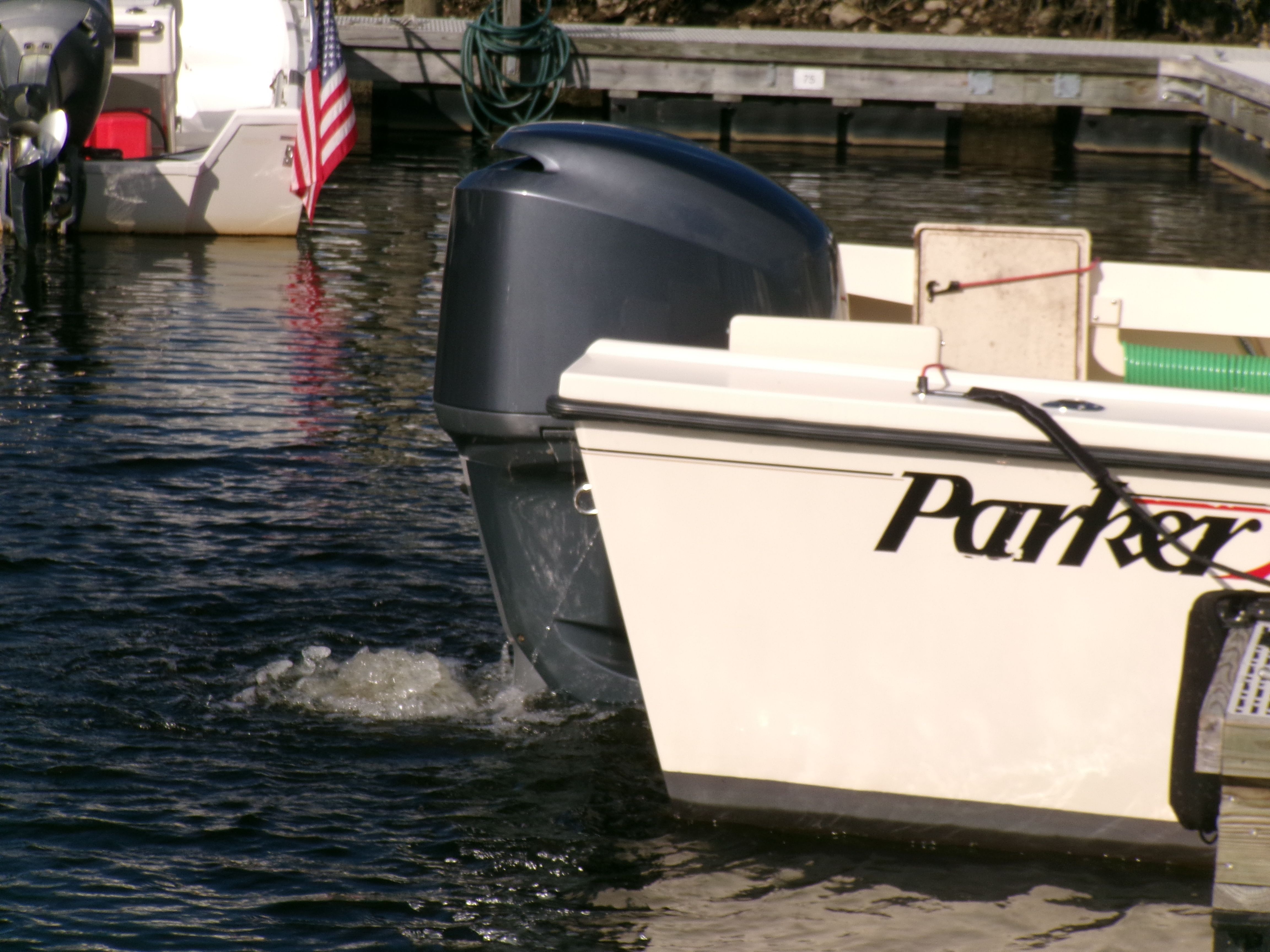 A 2007 Parker 2520 XL Sport Cabin boat is docked in the water.