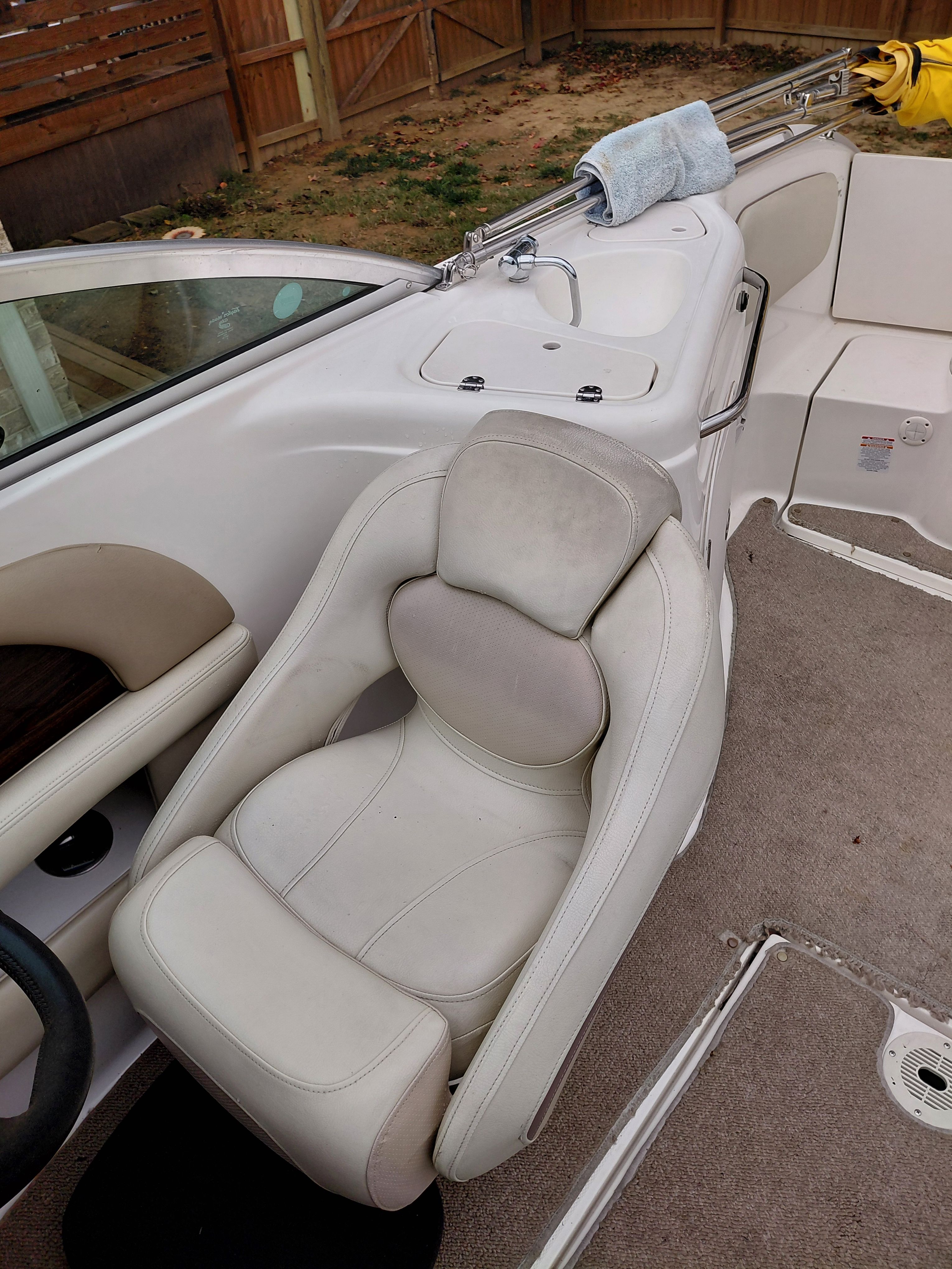 Interior of a 2005 Chaparral Sunestra 254 boat with beige seating.