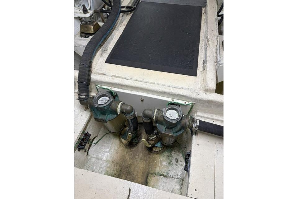 Engine compartment of a 2007 Navigator 5100 yacht, featuring gauges and hoses.