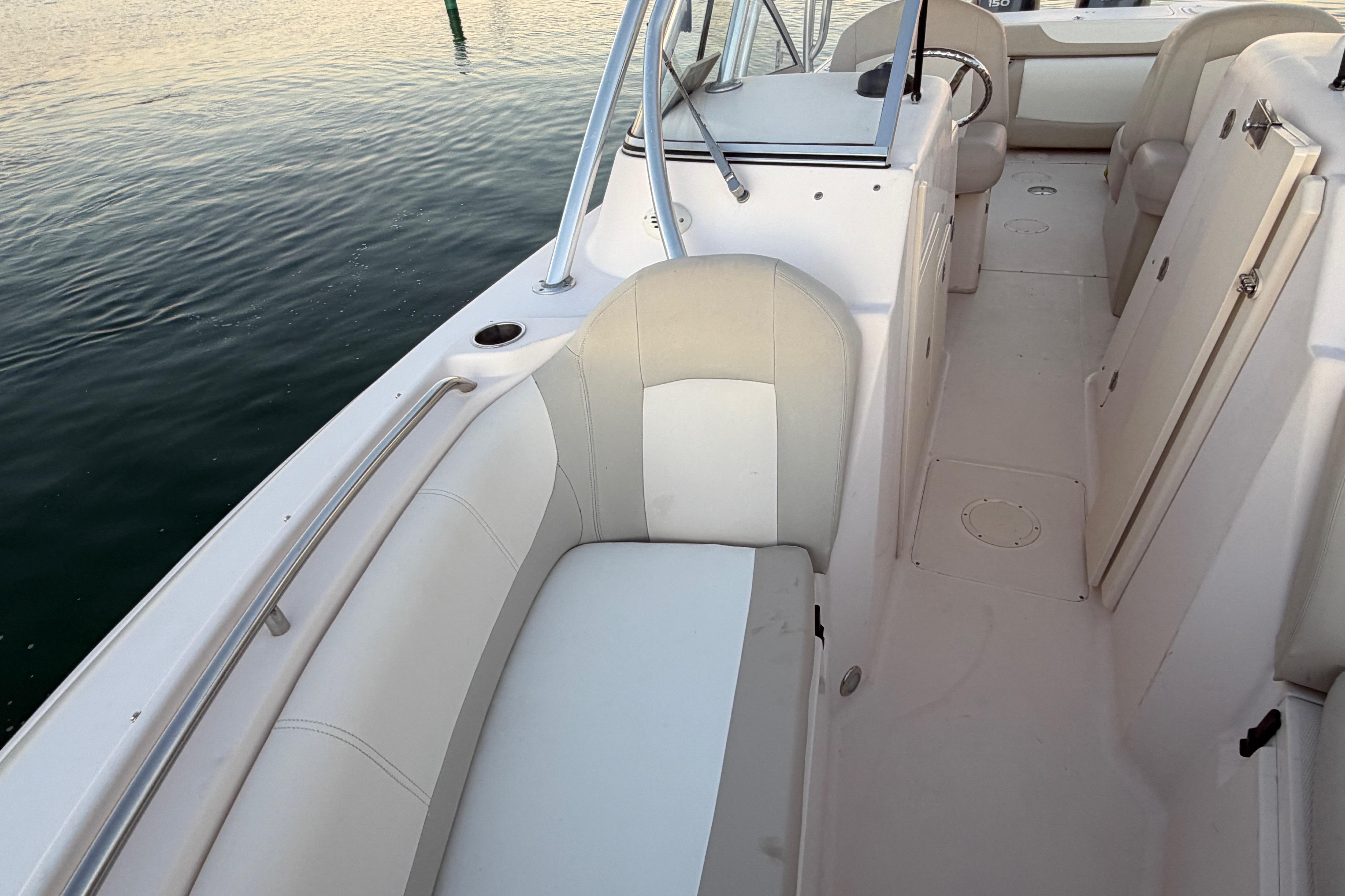 2012 Grady-White Freedom 275 boat interior with white seating and railing.