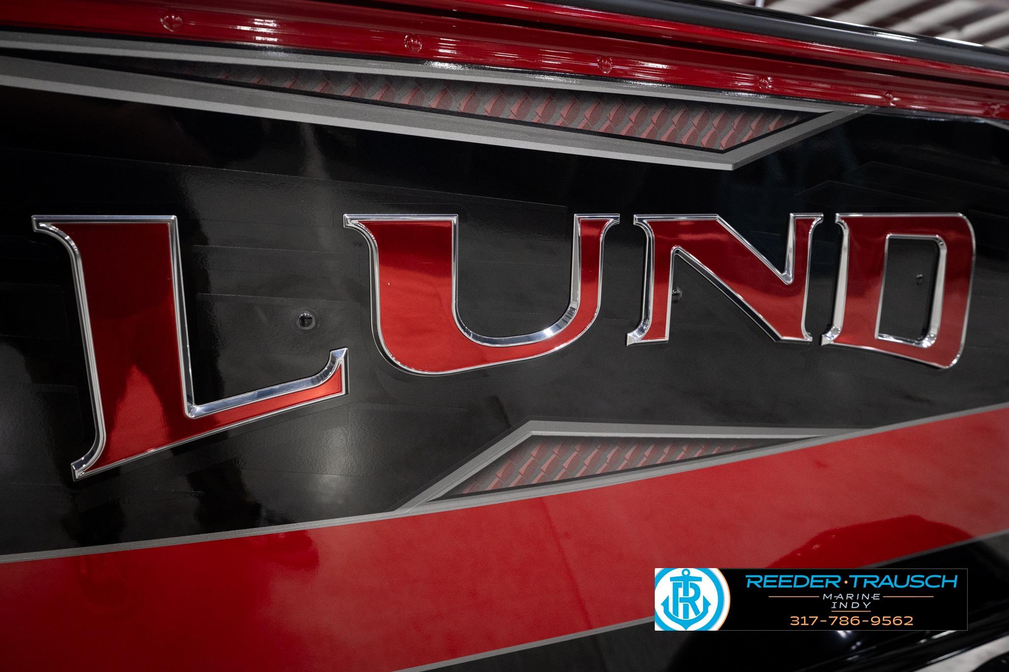 Close-up of 2026 Lund 1775 Impact XS SS boat logo with red and black design.