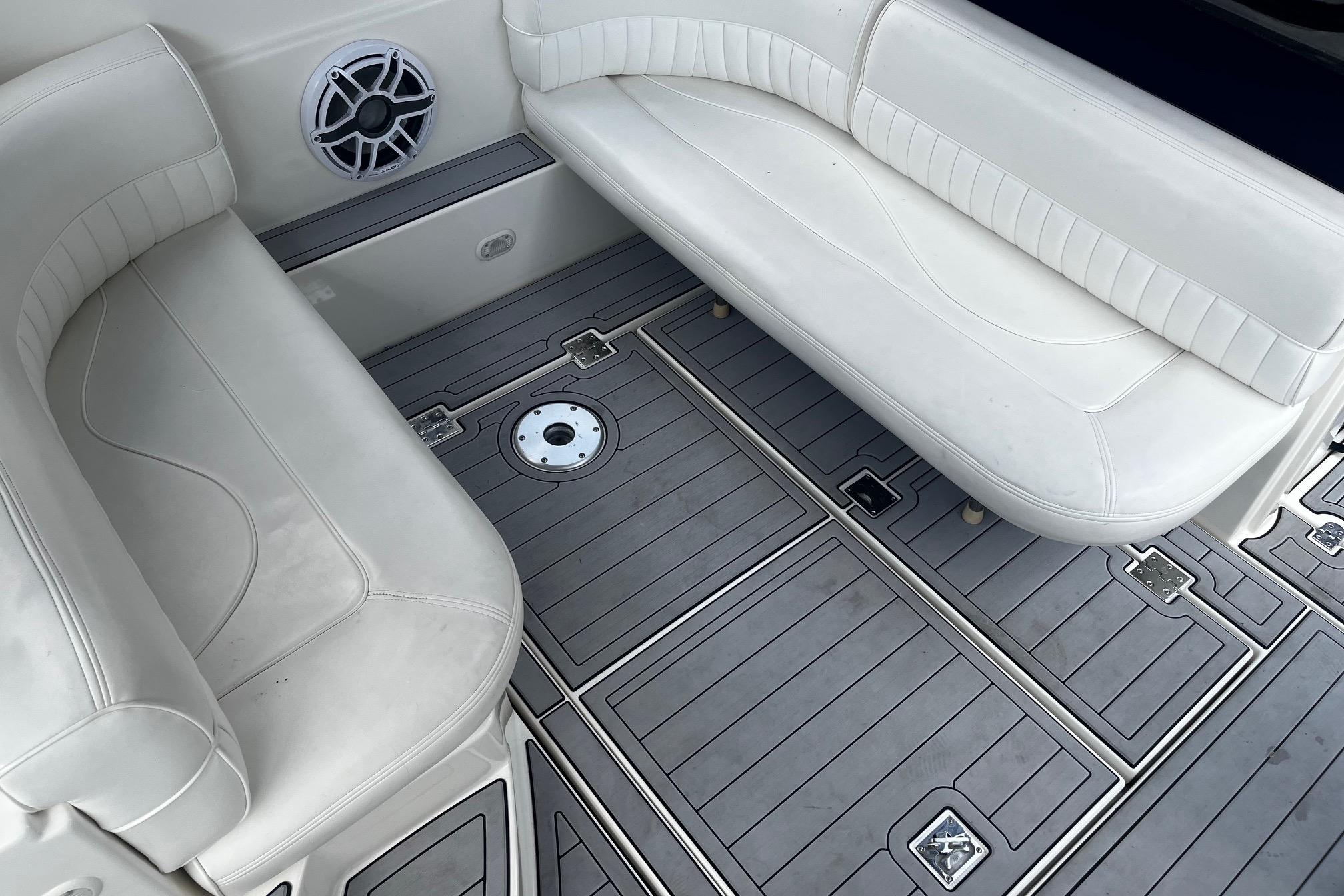 2004 Cruisers Yachts 280 CXi Express interior with white seating and gray flooring.