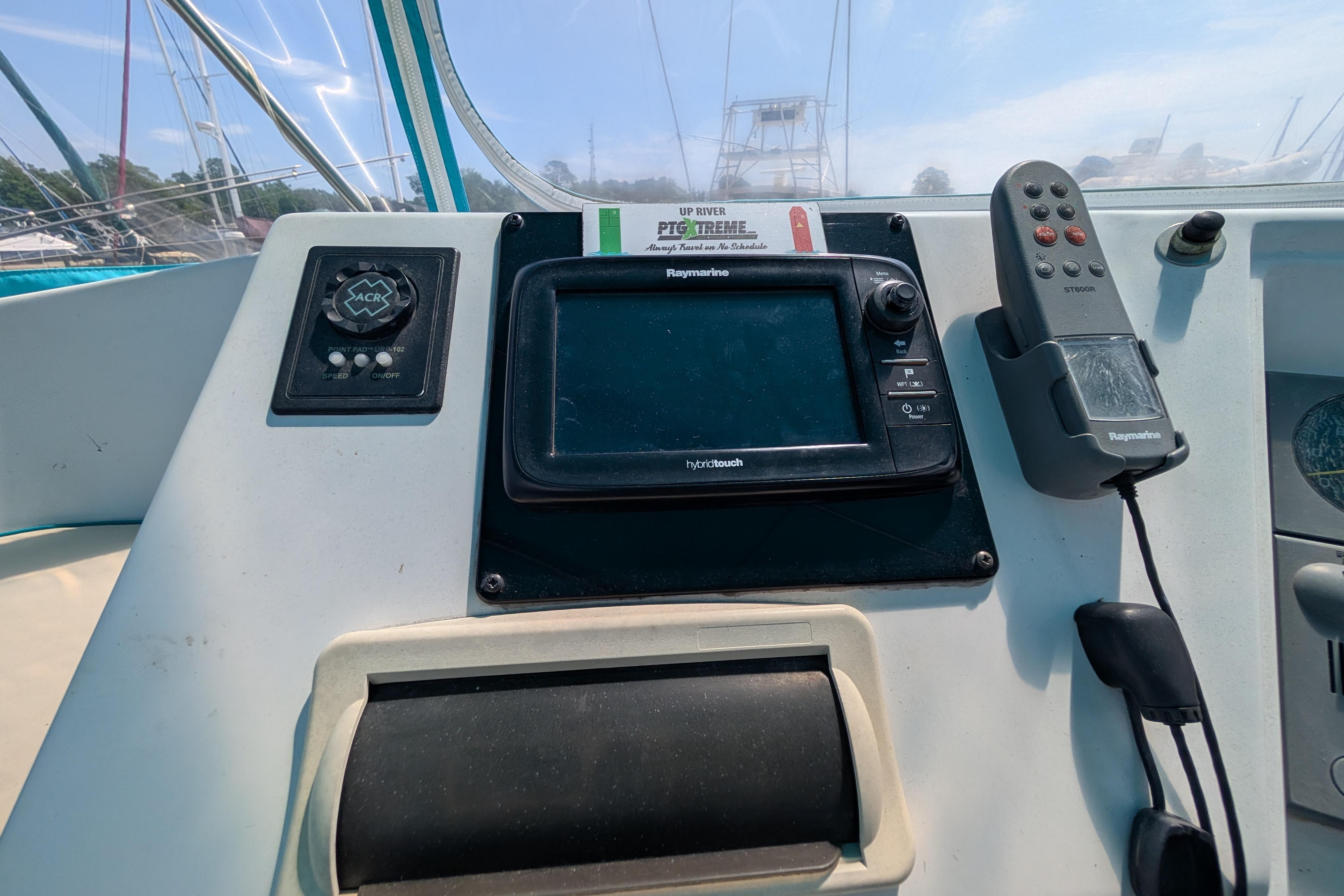 Control panel of a 2004 PDQ 34 Powercat with navigation equipment and remote.