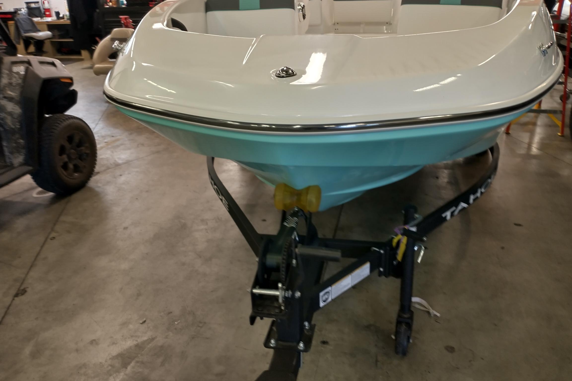 2026 Tahoe T16 boat on trailer in a garage setting.