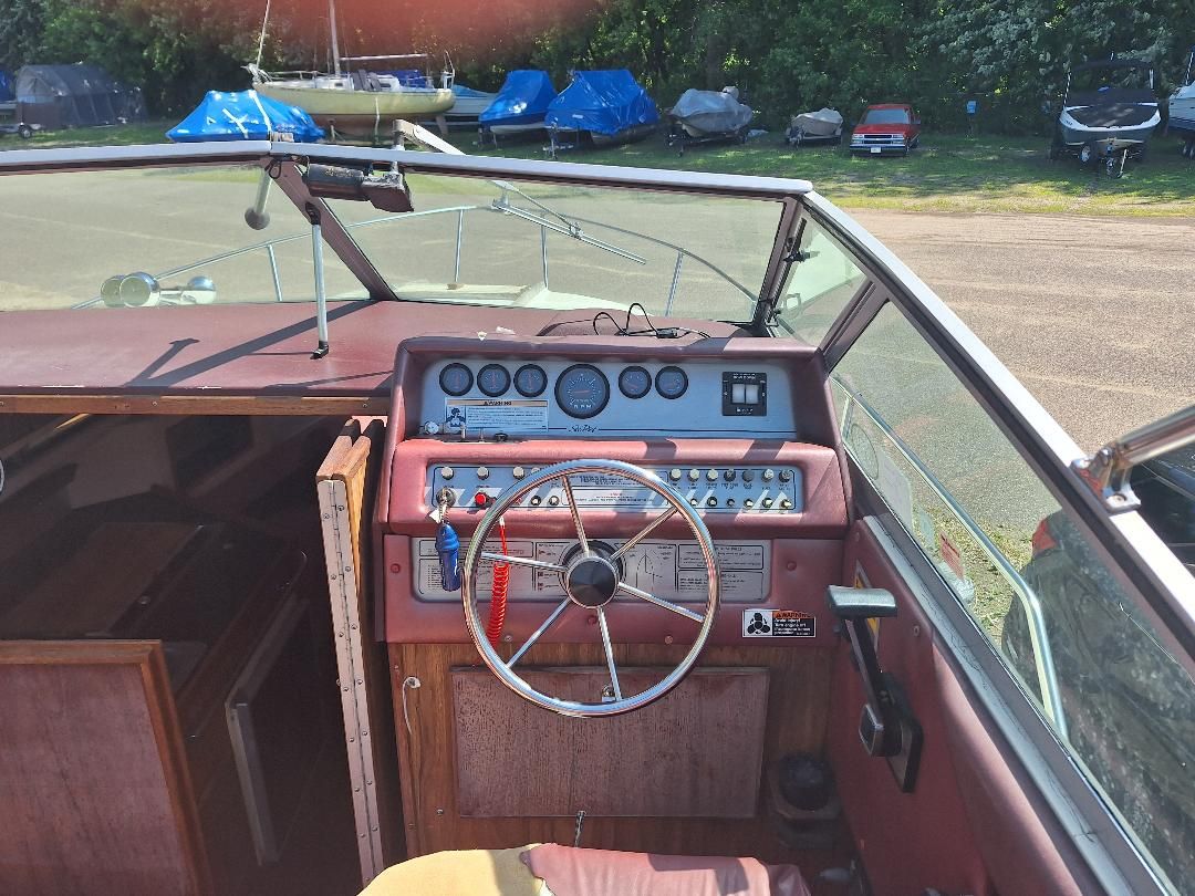Cockpit of a 1986 Sea Ray Weekender 230 boat with steering wheel and instruments.