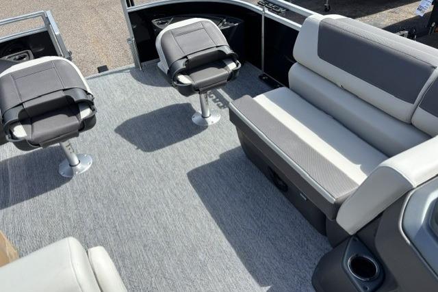 2026 Sun Tracker Fishin' Barge 22 DLX interior with seating and carpeted floor.