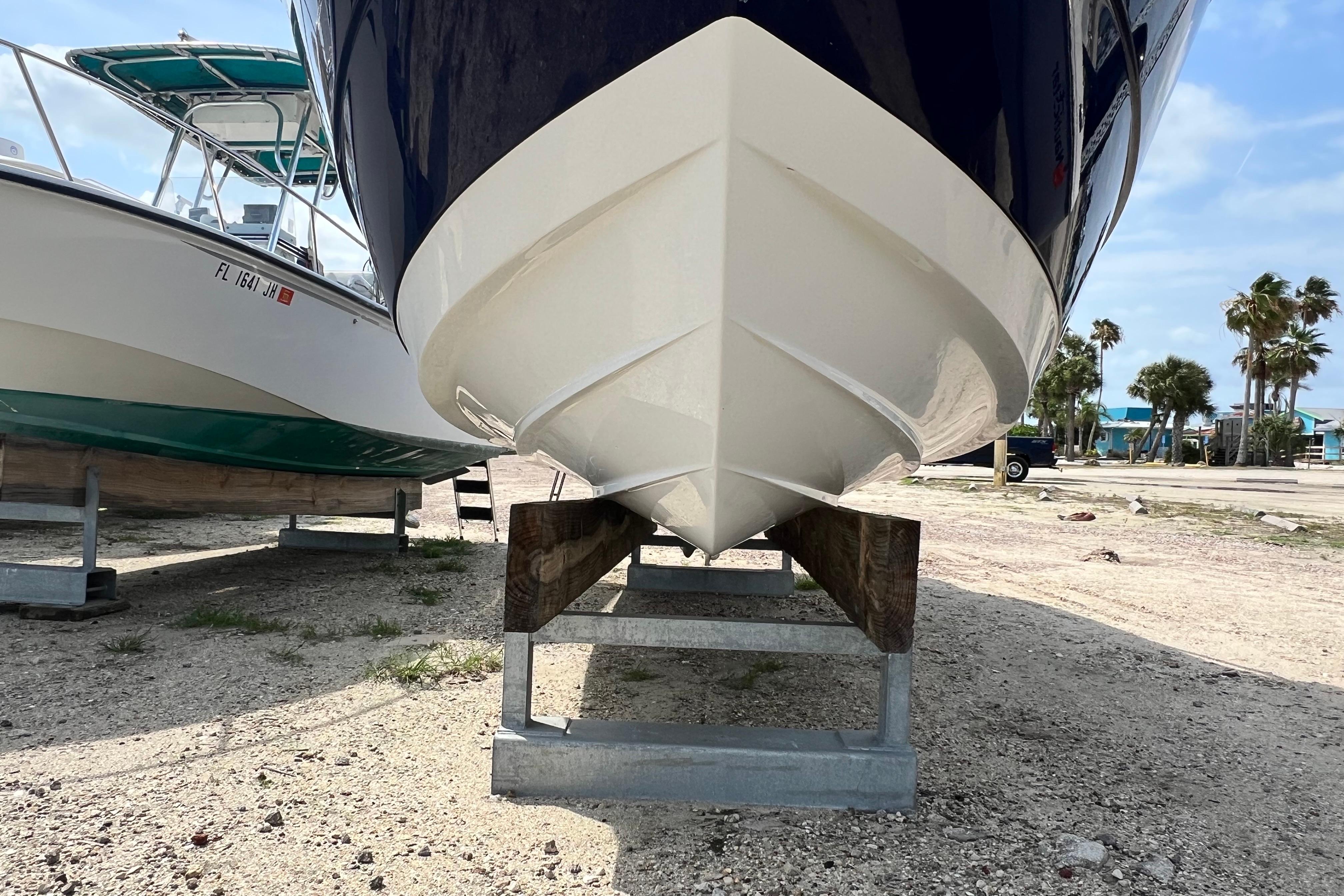 2015 Monterey 268SS Super Sport boat on dry dock, sunny day, palm trees in background.