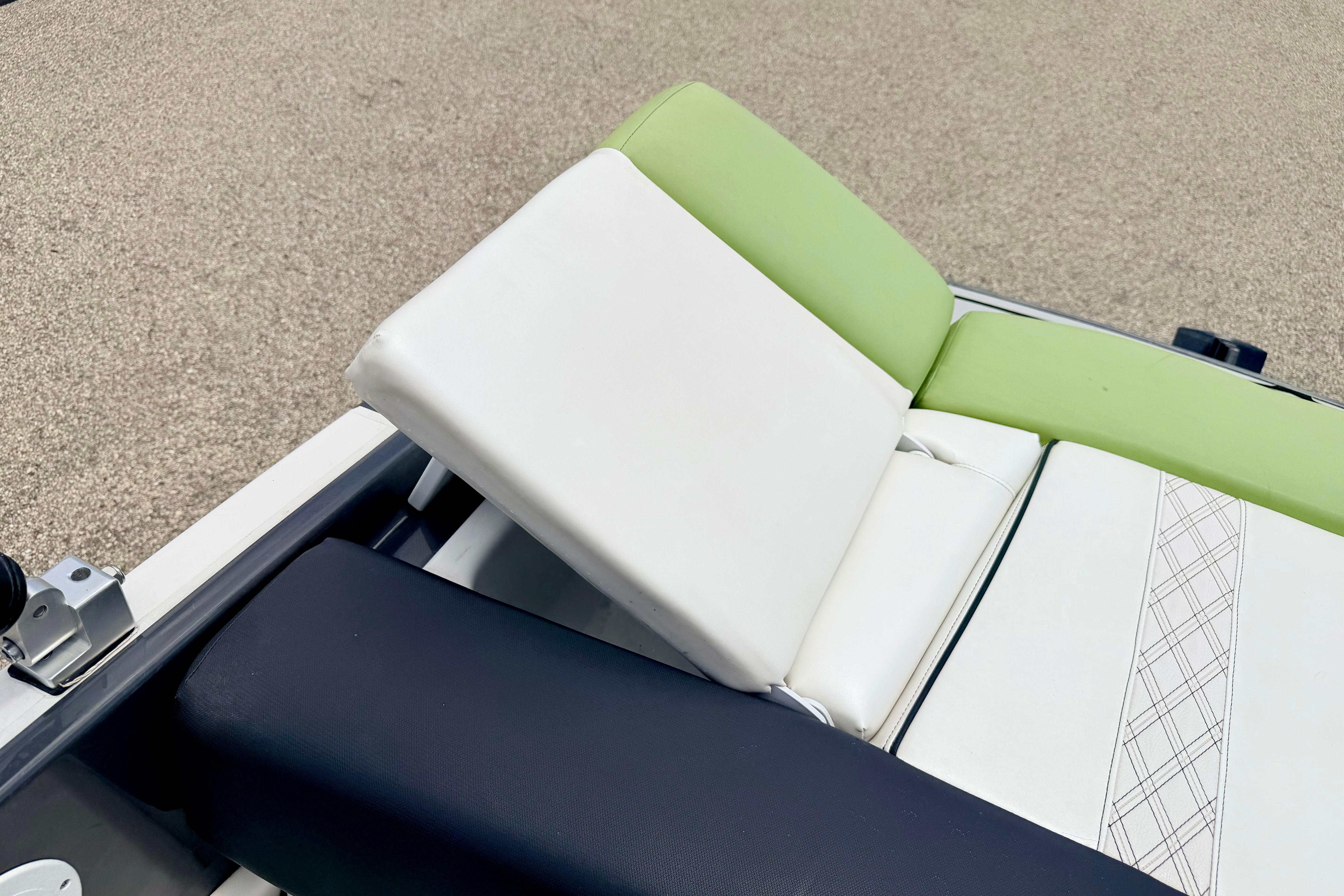 2018 Glastron GT 185 boat seat with white and green upholstery, featuring a sleek design.