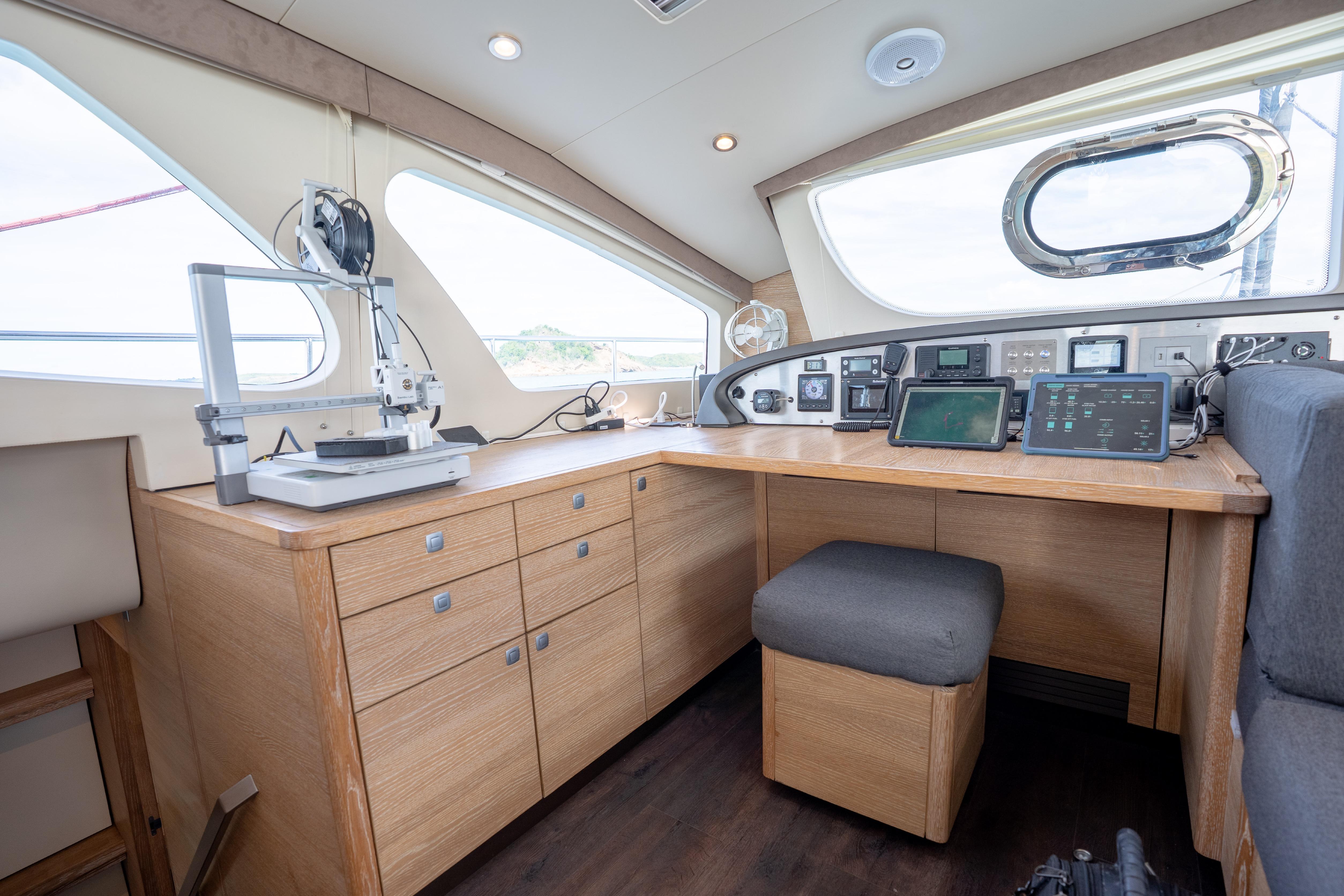 Navigation station inside 2020 Xquisite Yachts X5 Sail, featuring modern equipment and wooden cabinetry.