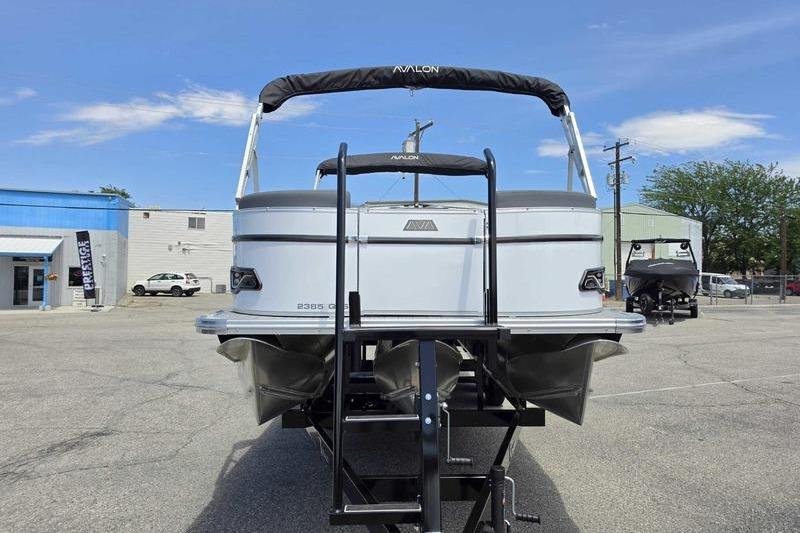 2026 Avalon Catalina Quad Lounge Shift boat on trailer in parking lot.