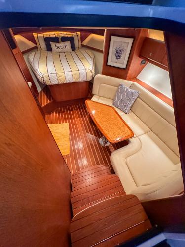 Luxurious 2006 Tiara Yachts 3200 Open cabin with cozy seating and elegant wood finishes.