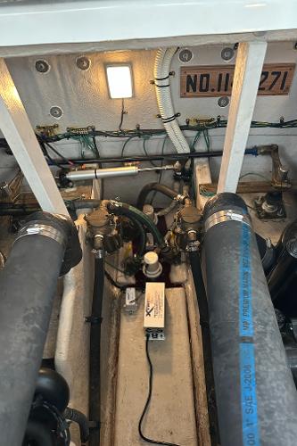 Engine compartment of 2004 Sea Ray 380 Sundancer with visible hoses and wiring.