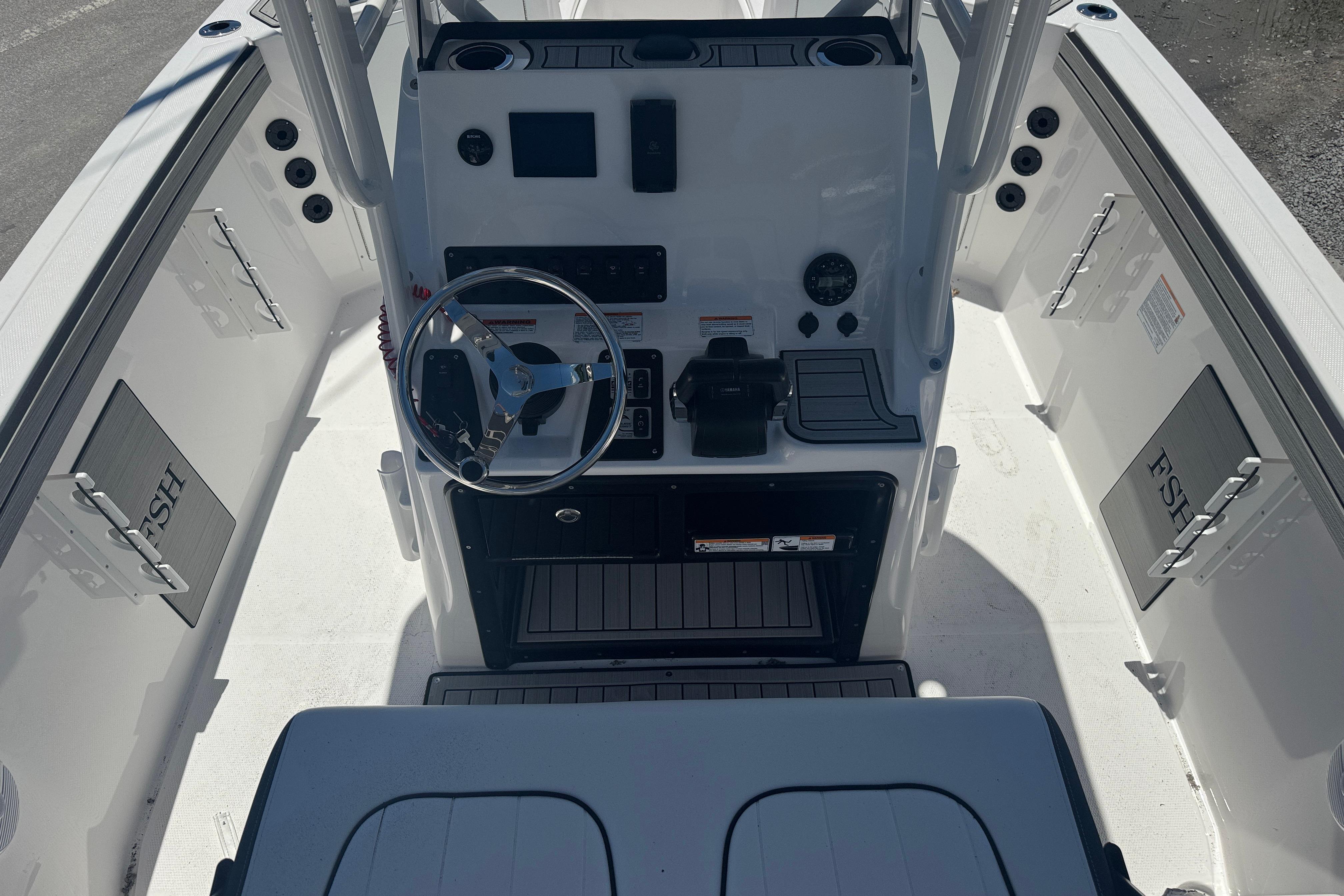 2026 Yamaha Boats 220 FSH Sport console with steering wheel and controls.