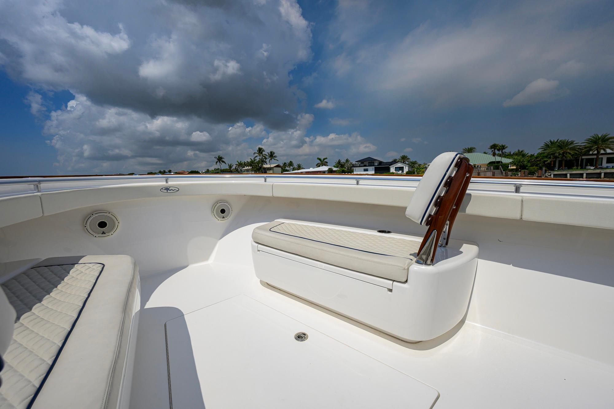 2020 Valhalla Boatworks V-41 interior with cushioned seating under a cloudy sky.