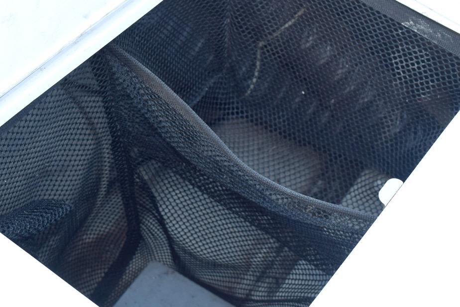 Mesh storage compartment in a 2006 Cobalt 240 boat.