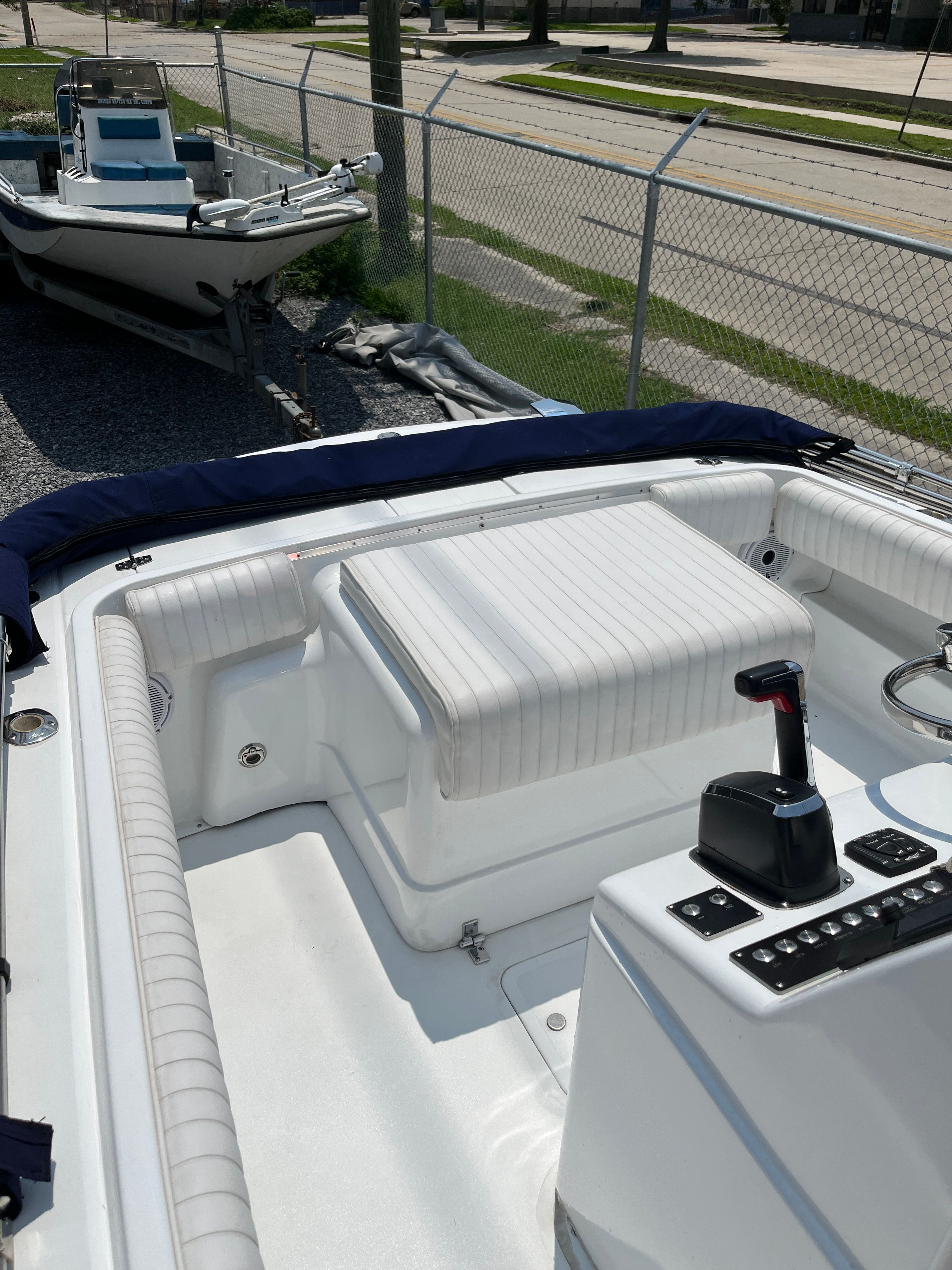 Interior of a 1970 Bertram Sportsman boat, white upholstery, visible control console.