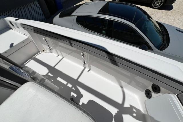 2019 Yamaha Boats 190 FSH Sport interior with car in background, showcasing sleek design.