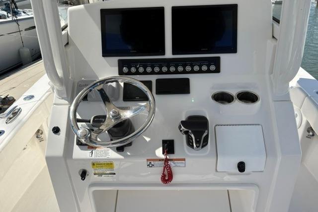 2024 Regulator 24XO boat dashboard with dual screens and steering wheel.