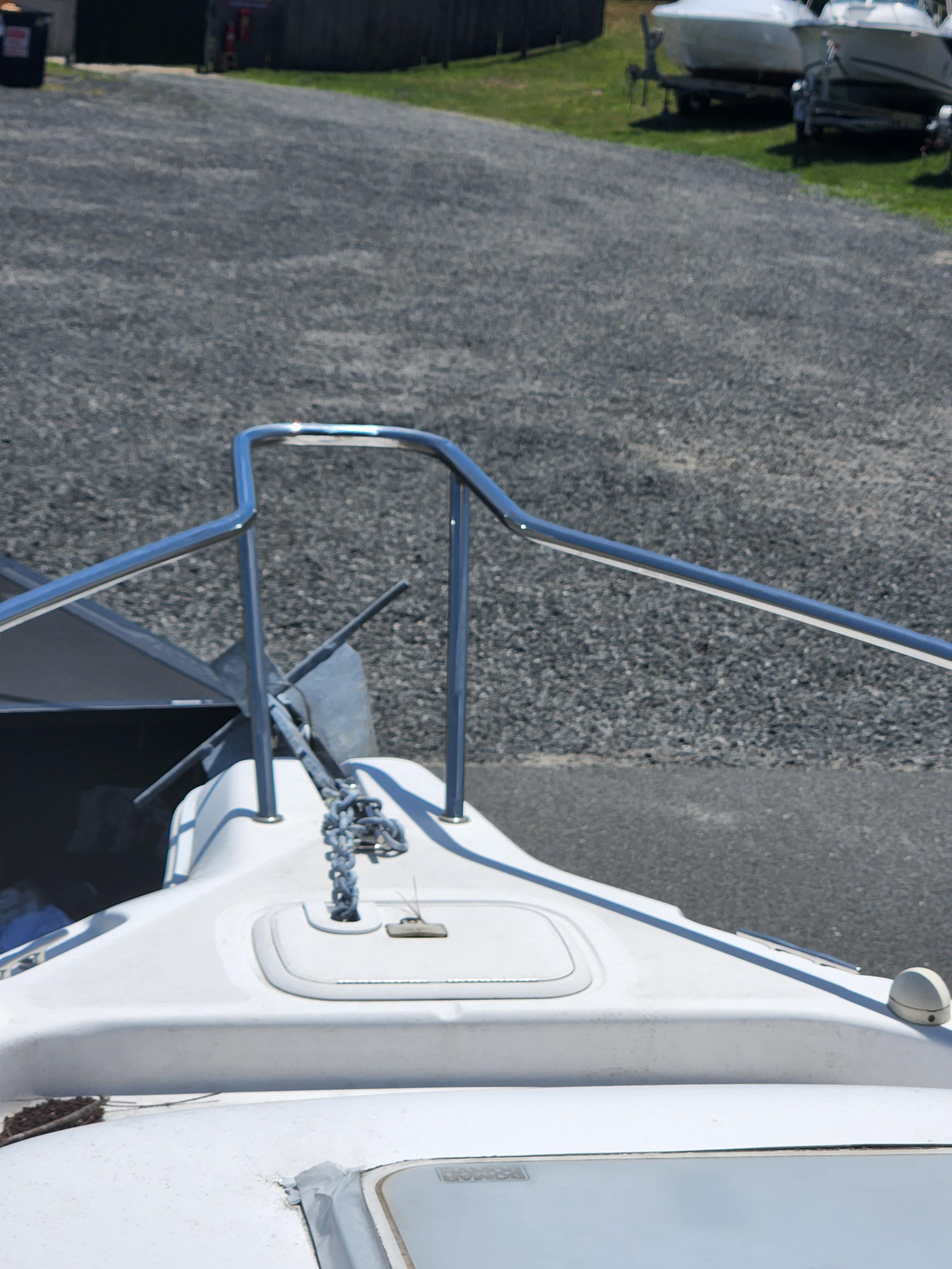 2006 Pro-Line 23 Walk boat bow with anchor and railing.