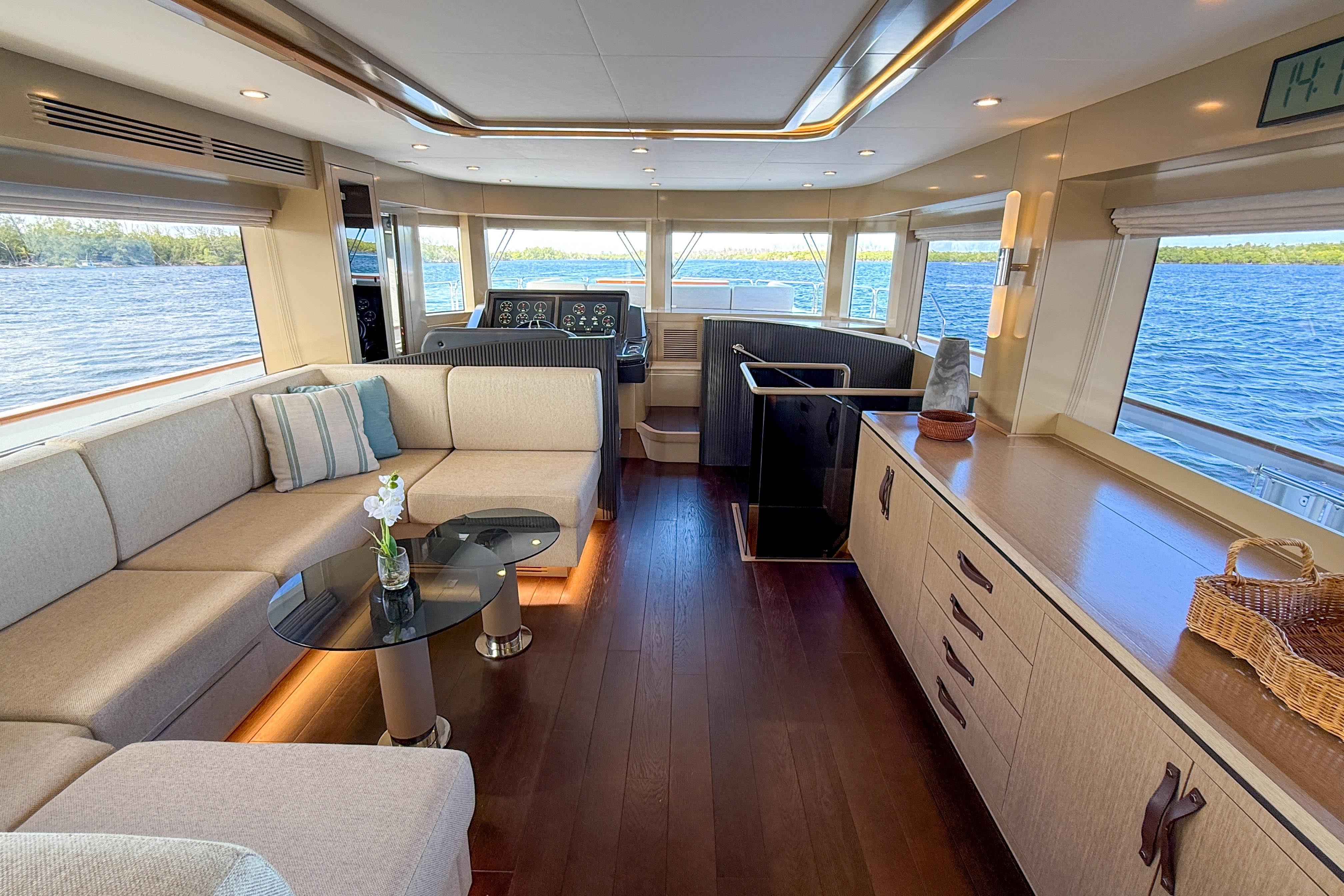 Luxurious interior of 2023 Sirena 68 yacht with elegant seating and panoramic windows.