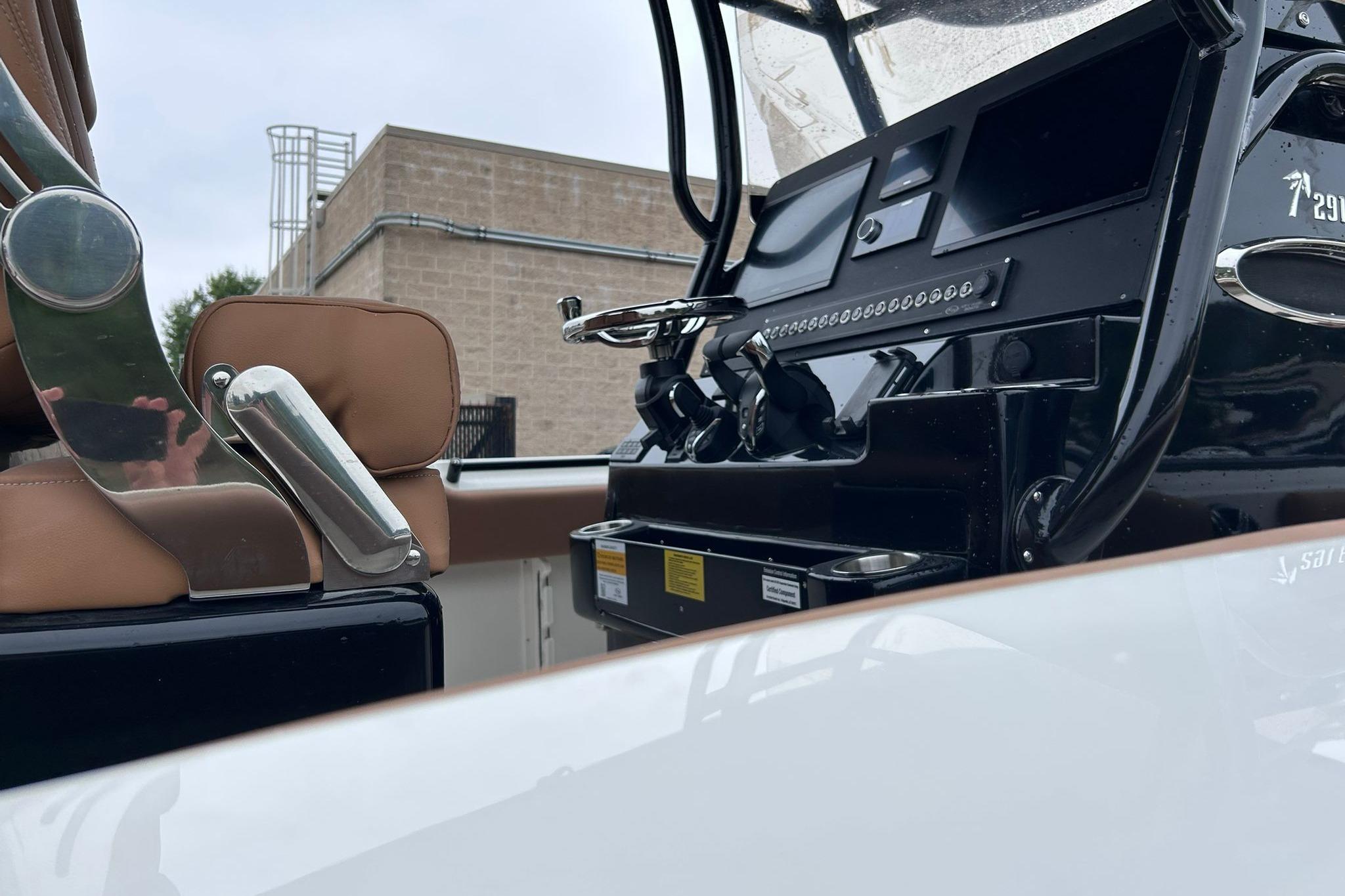 2026 Key West 291 FS boat interior with modern controls and brown seating.