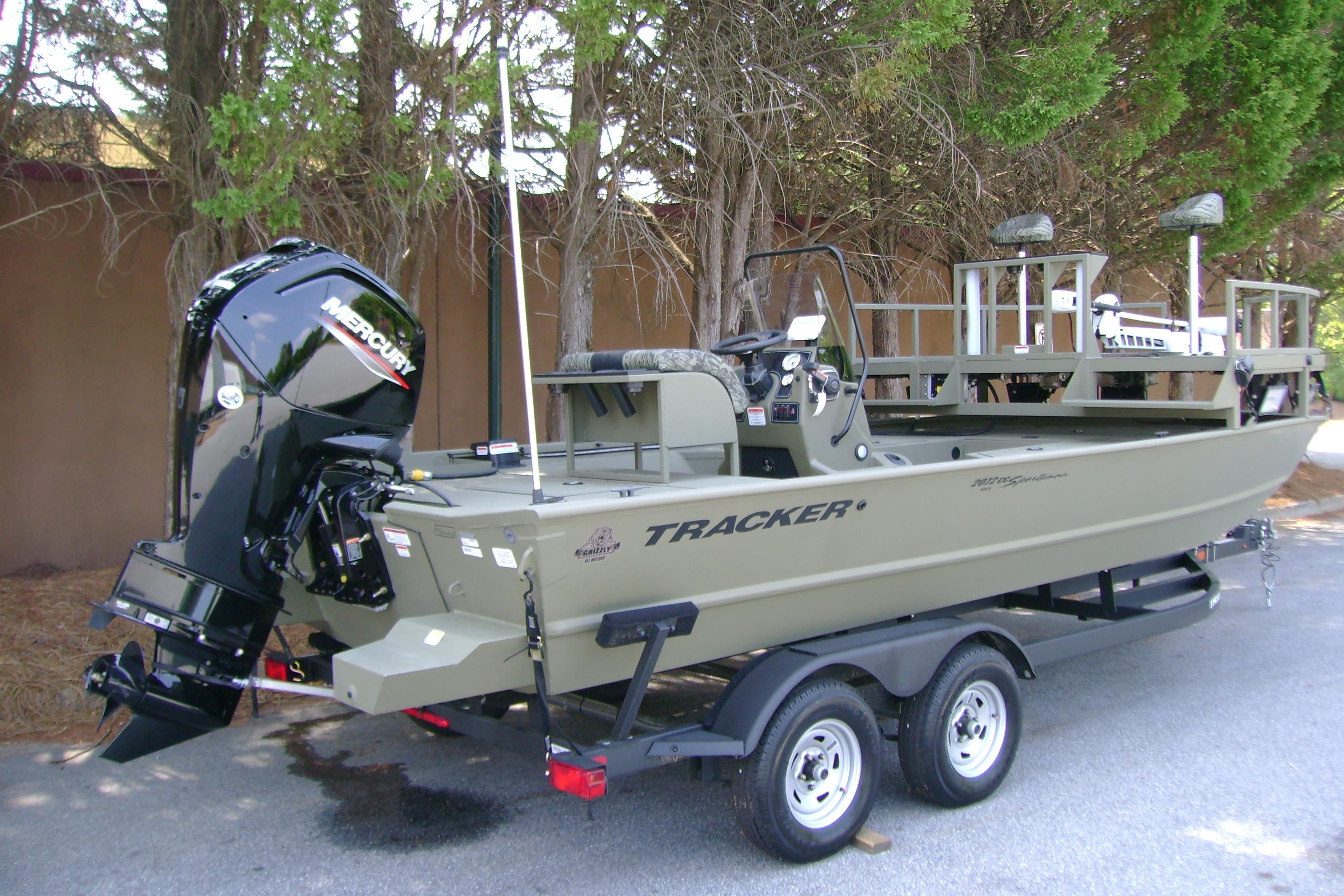 2026 Tracker Grizzly 2072 CC Sportsman boat on trailer, featuring Mercury outboard motor.