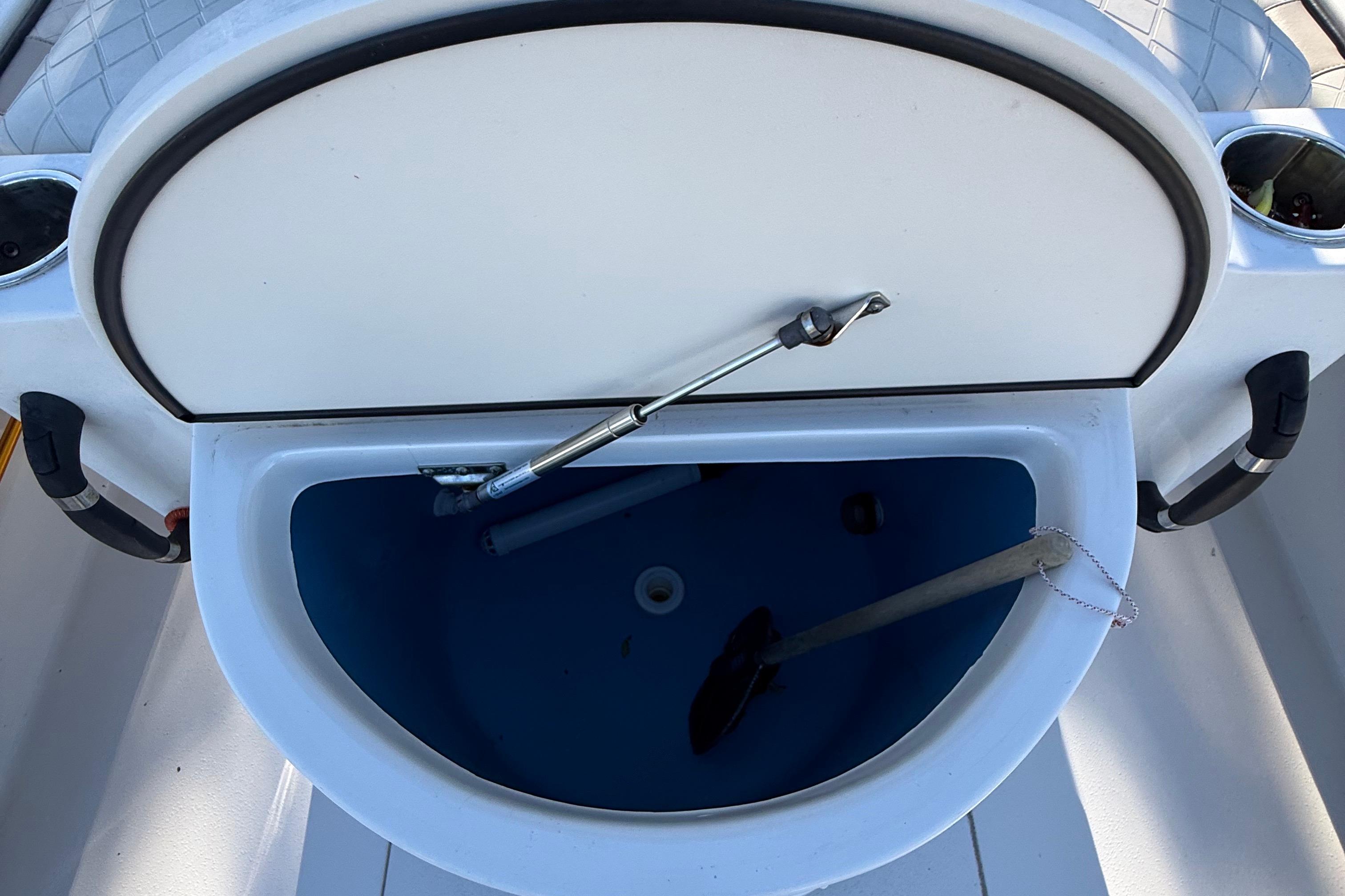 2021 Carolina Skiff 26 Ultra Elite boat storage compartment open.