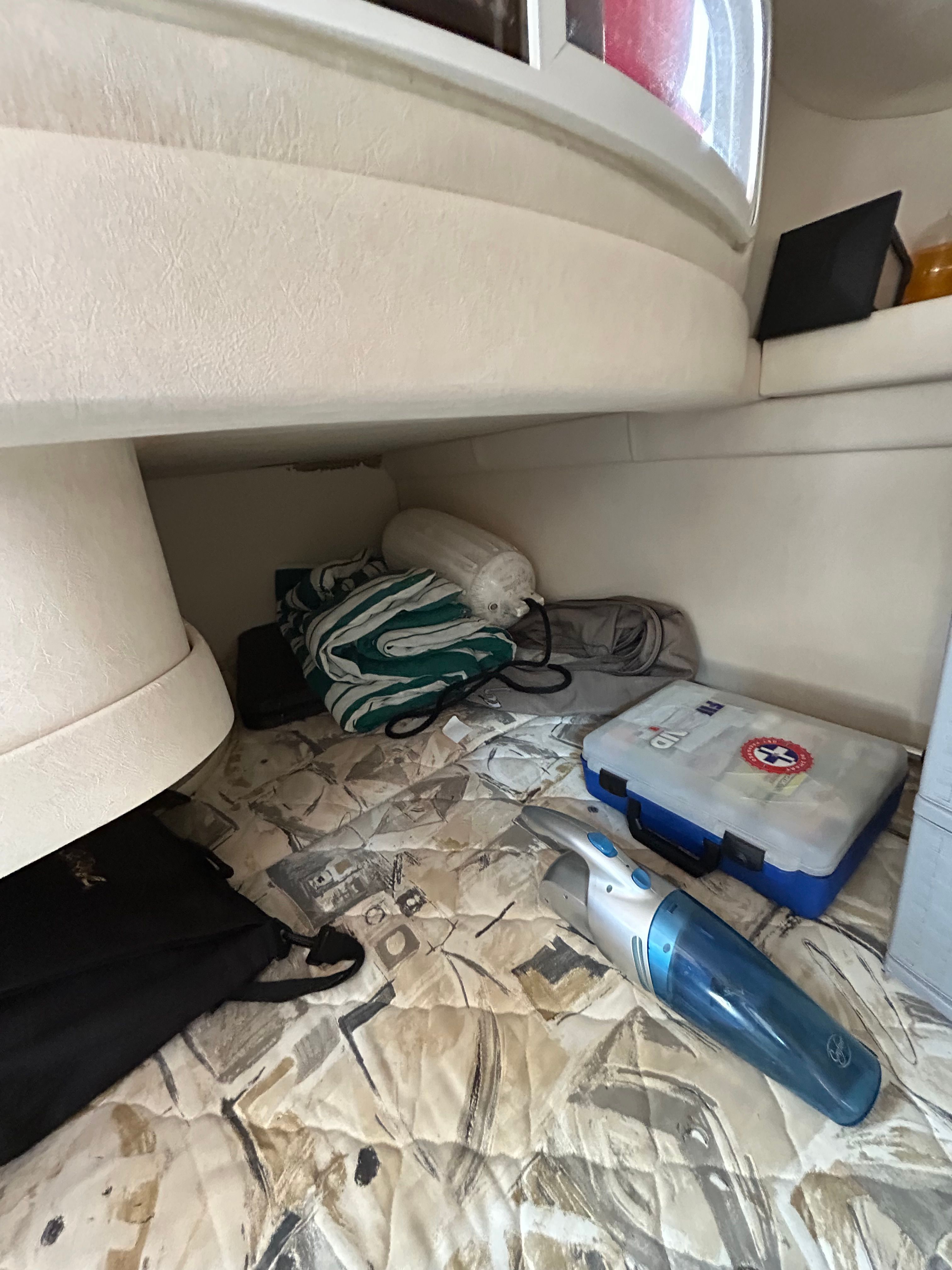 Interior of a 1999 Sea Ray 270 Sundancer Special Edition with storage and accessories.
