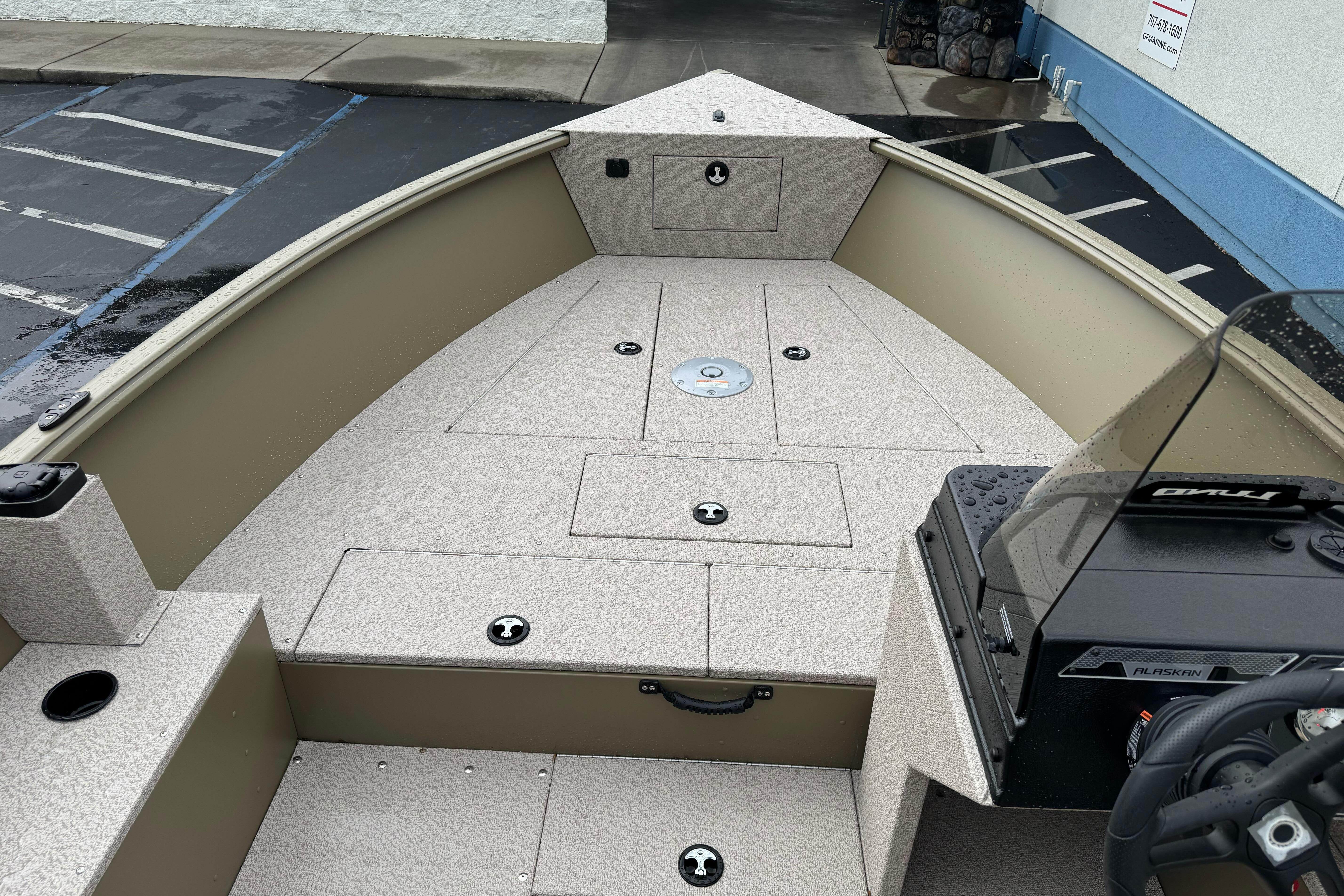 2026 Lund 2075 Alaskan SS boat interior with storage compartments and steering console.