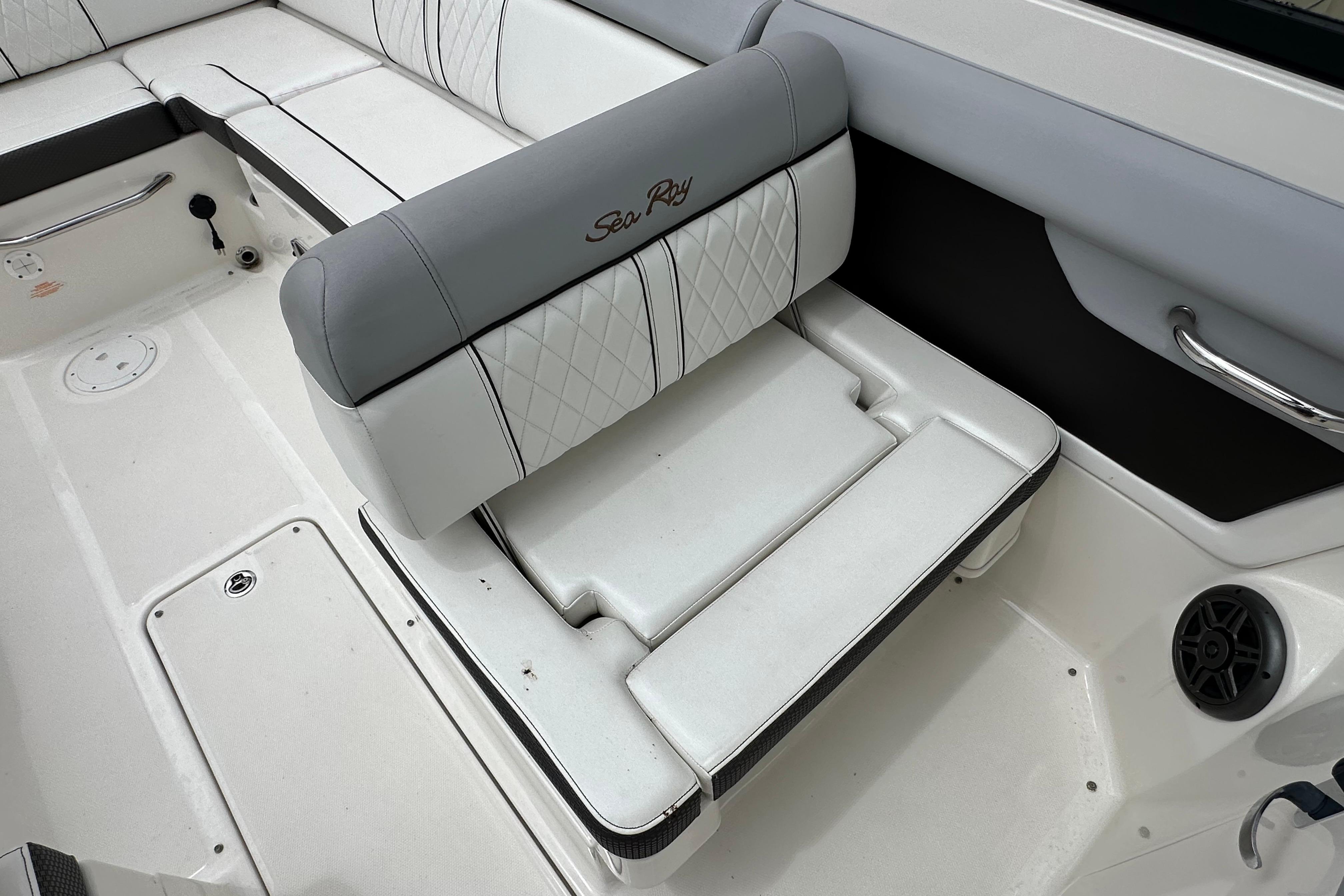 Interior seating of 2016 Sea Ray 270 Sundeck boat, featuring white and gray upholstery.