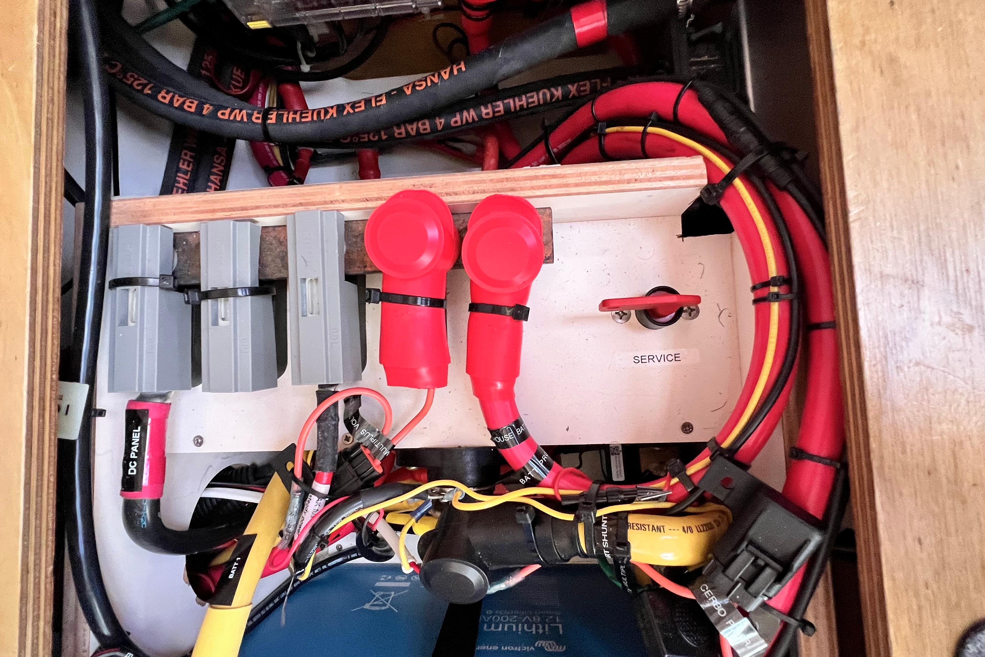 Electrical panel of a 2016 Hanse 455 yacht with cables and switches.