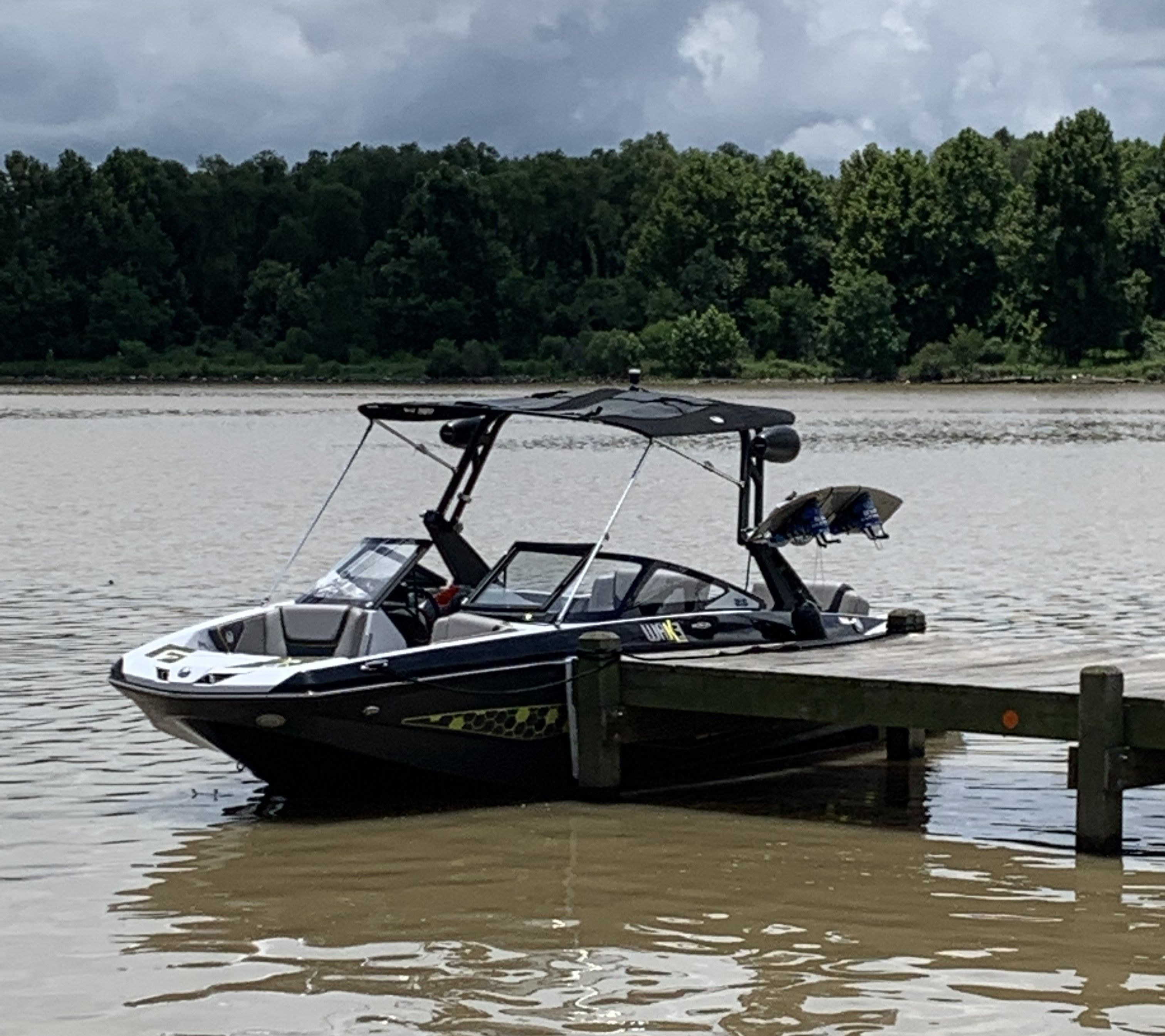 2020 Scarab Wake 215 boat docked at lakeside.