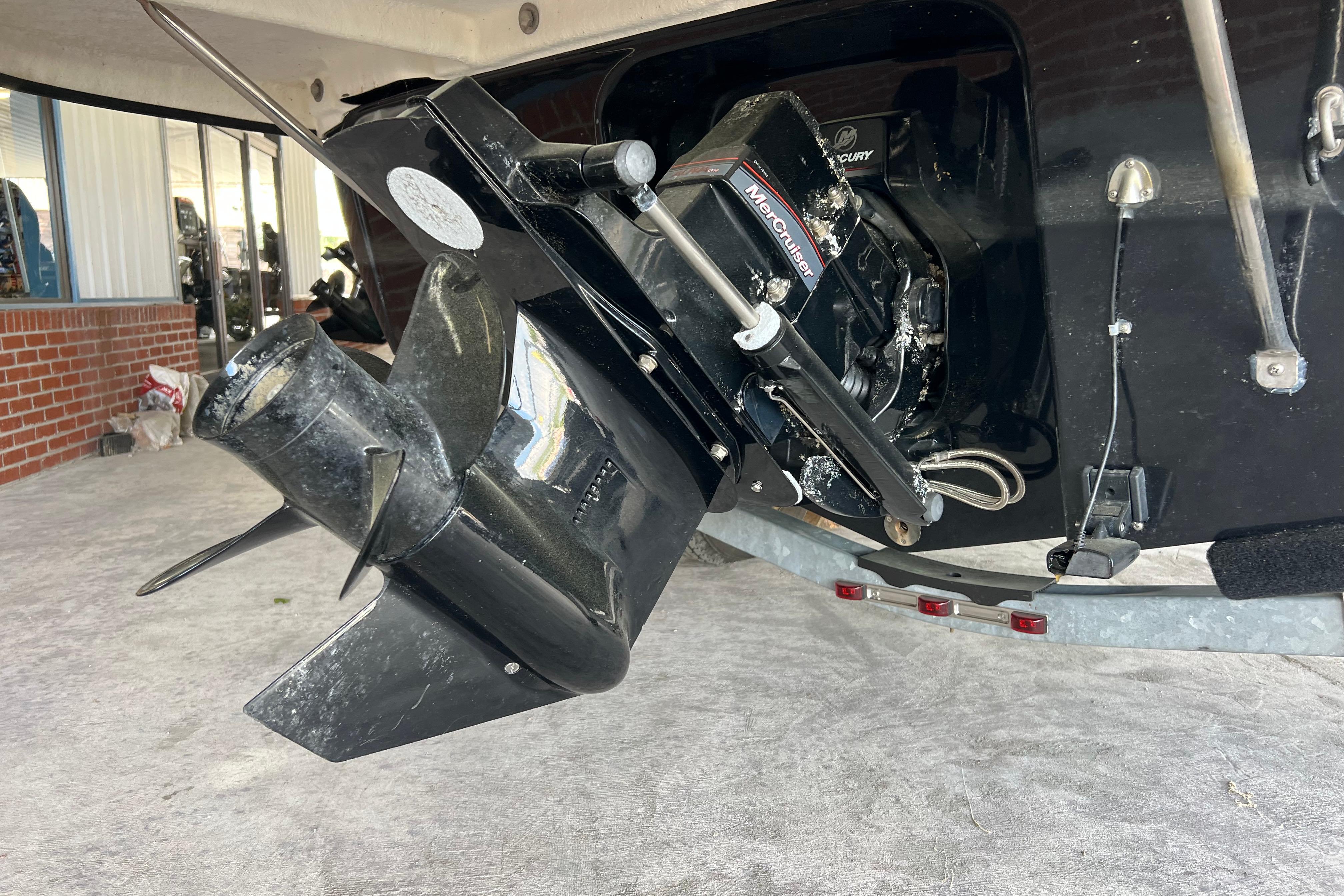 2017 Bayliner 195 Deck Boat with MerCruiser engine, close-up of outdrive and propeller.