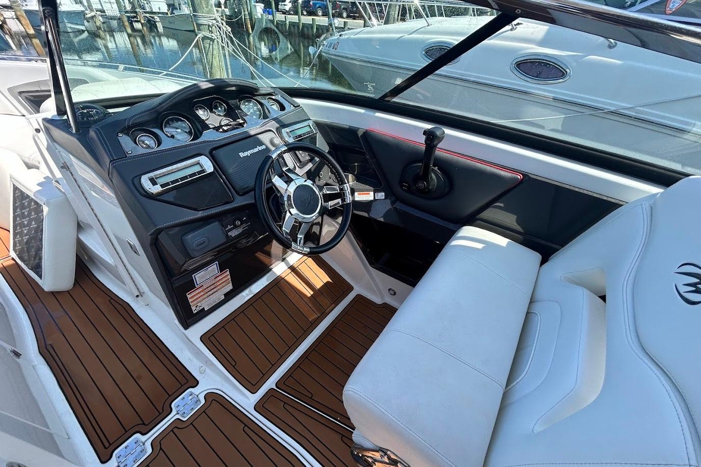 2015 Monterey 288 Super Sport boat interior with steering wheel and dashboard controls.