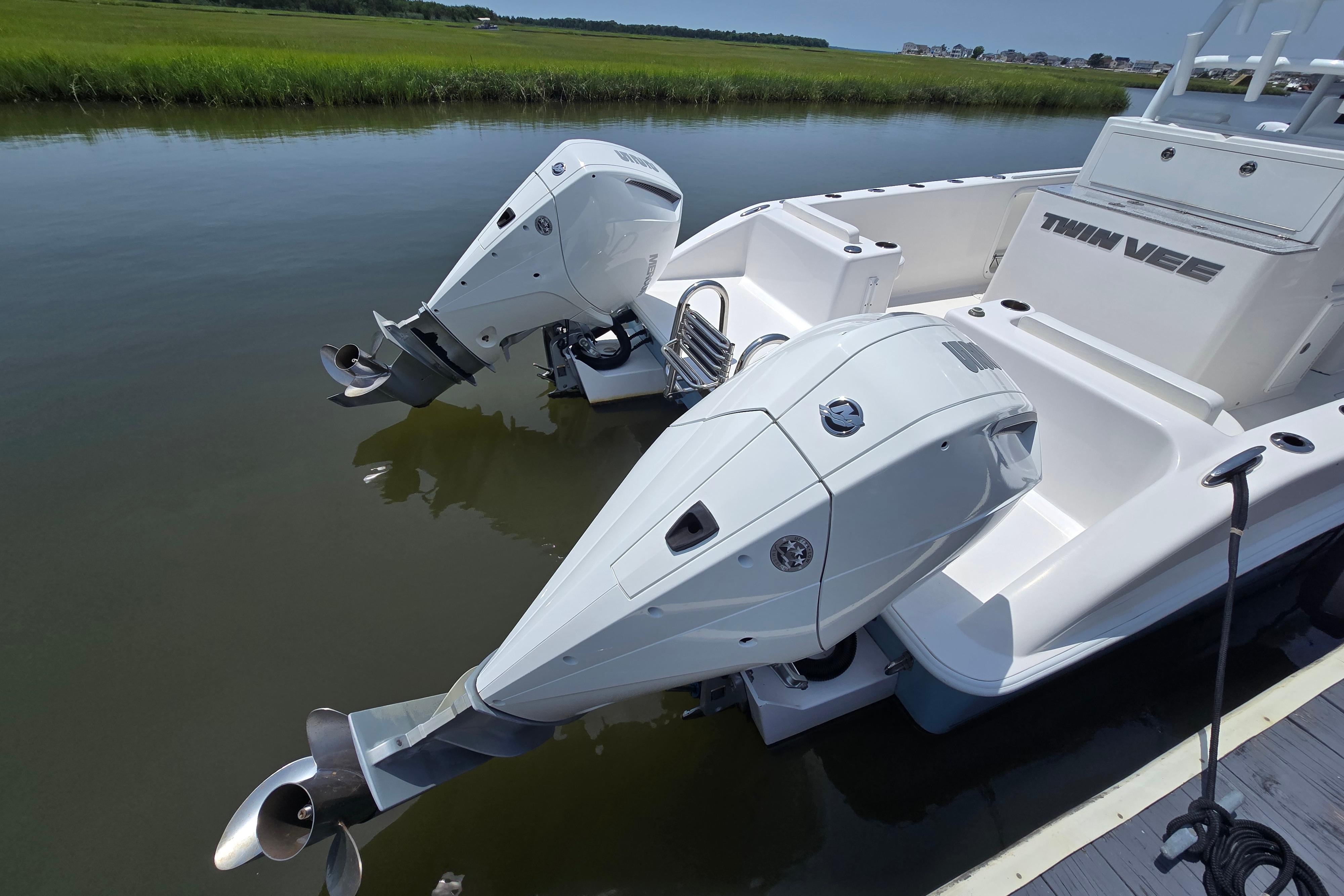 2021 Twin Vee 280 GFX CC boat with dual outboard motors on calm water.