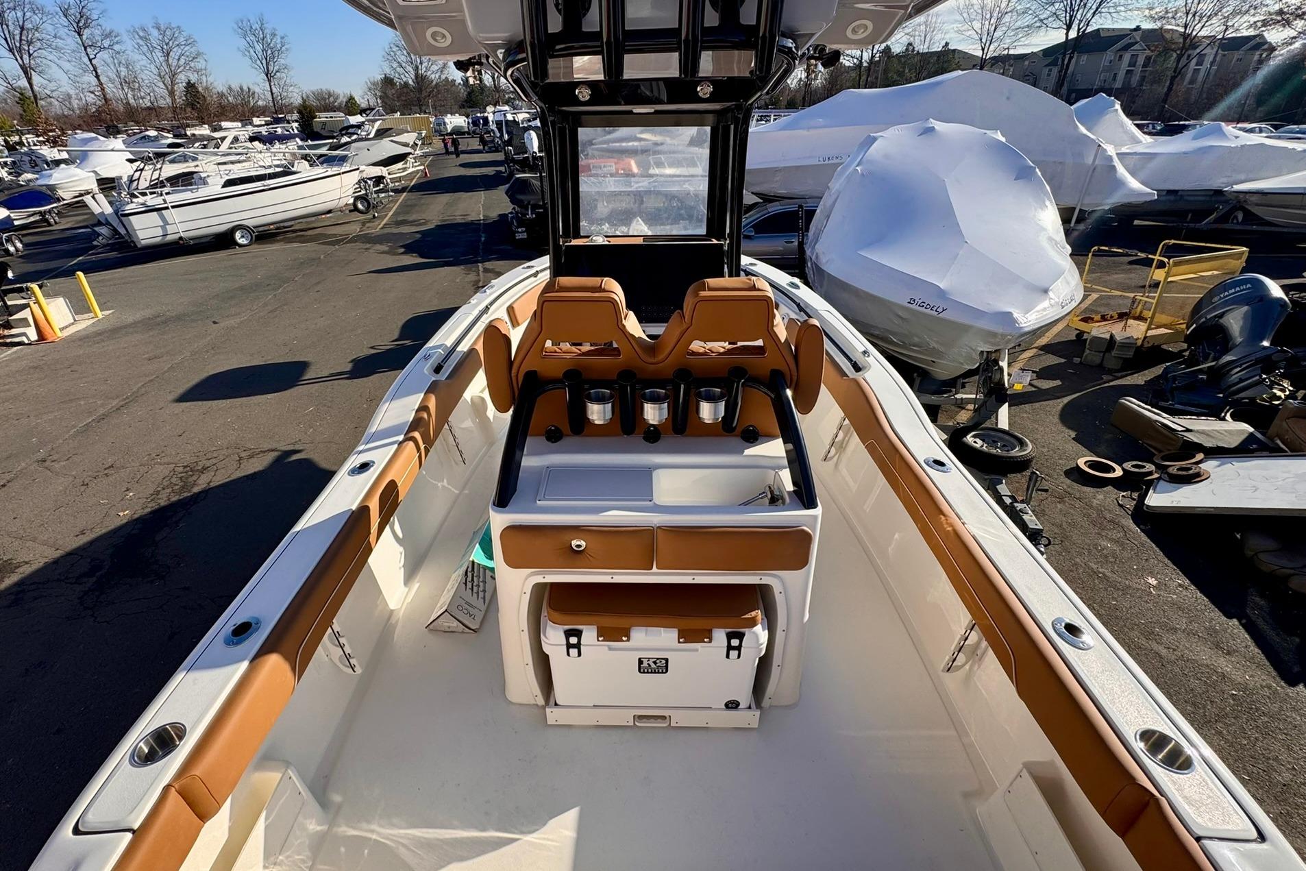 2026 Key West 239 FSR boat interior with tan seating and storage compartments.