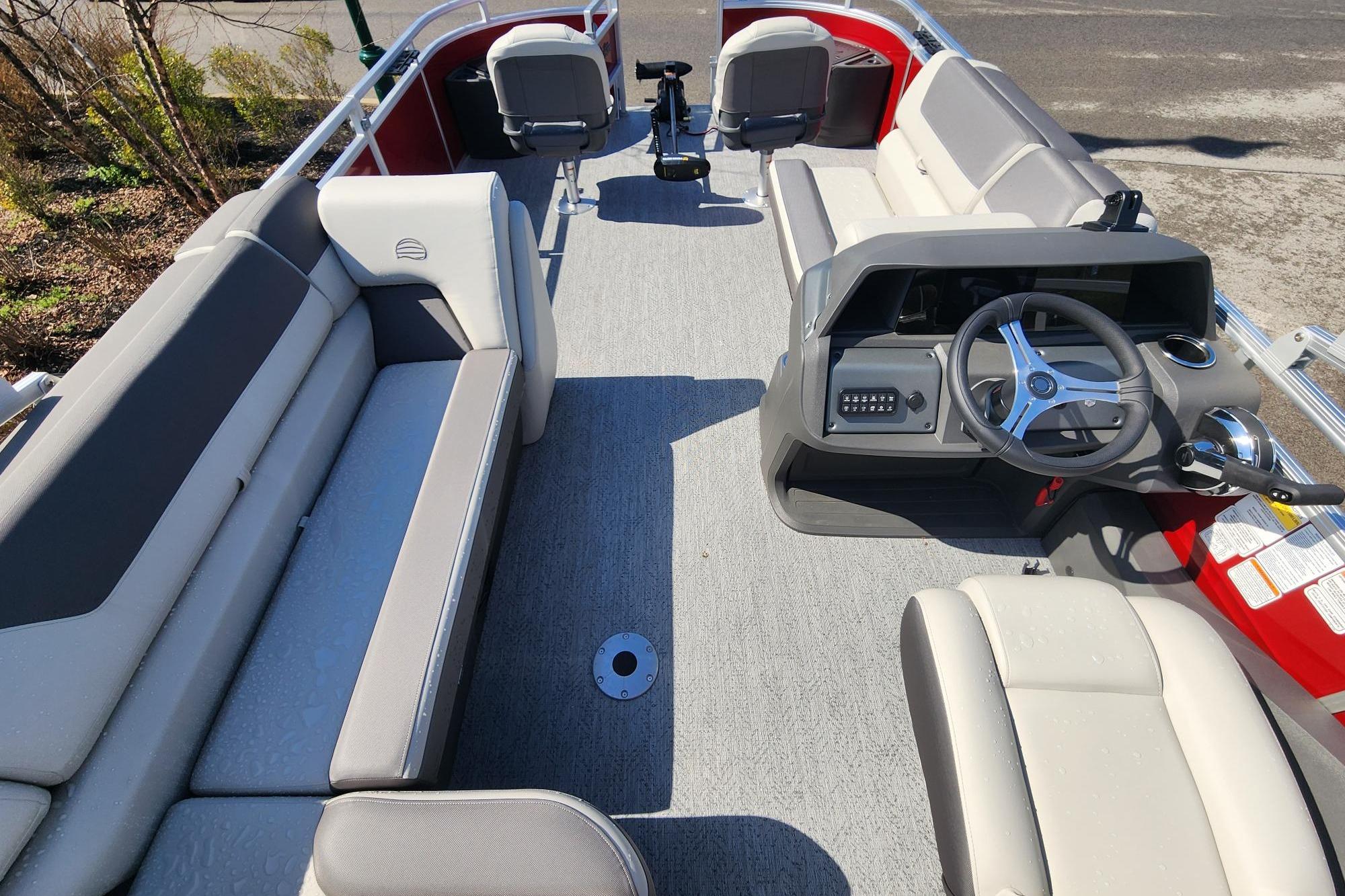 2026 Sun Tracker Fishin' Barge 22 DLX interior with seating and steering console.