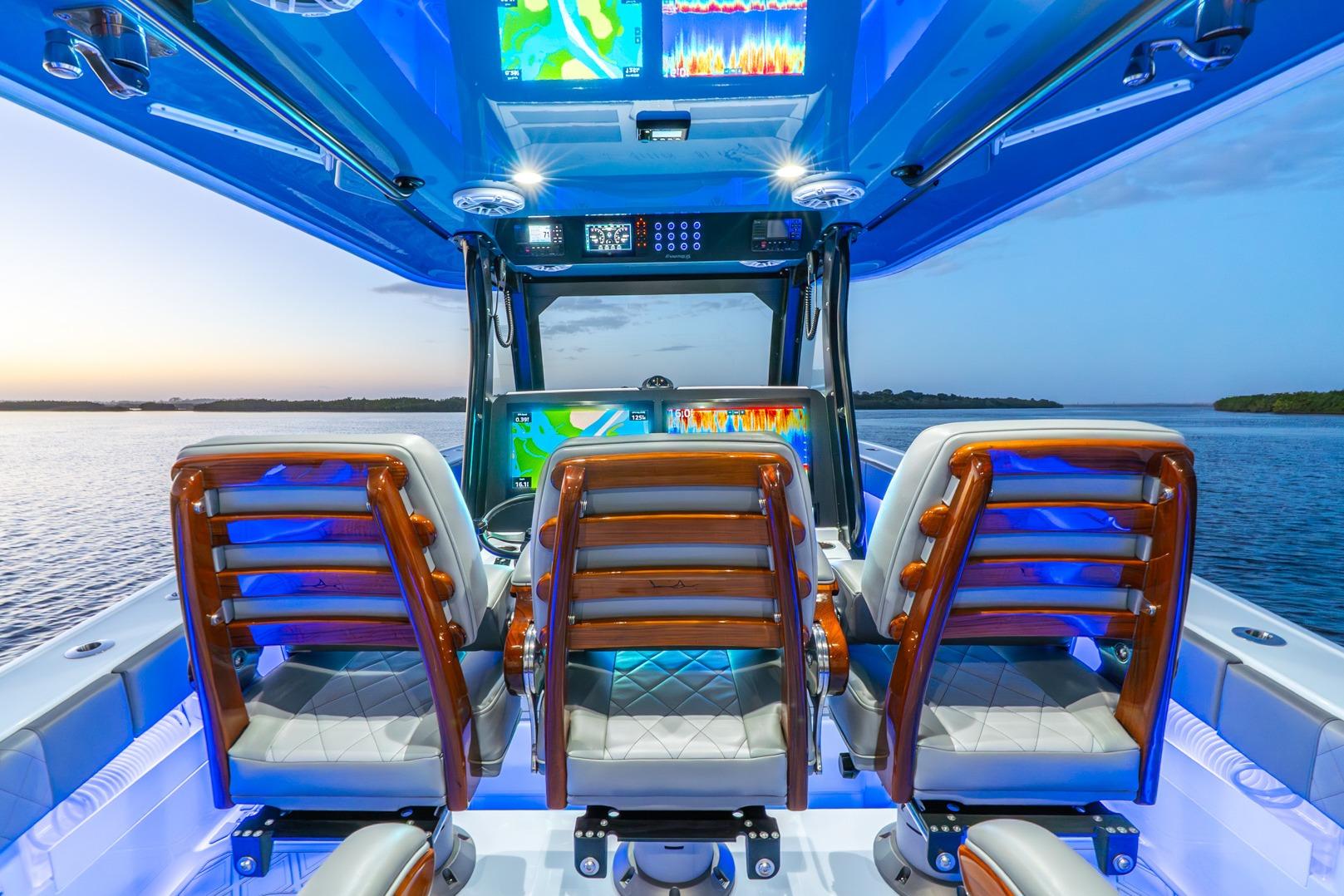 Interior of 2025 Freeman 43 boat with illuminated dashboard and luxurious seating.
