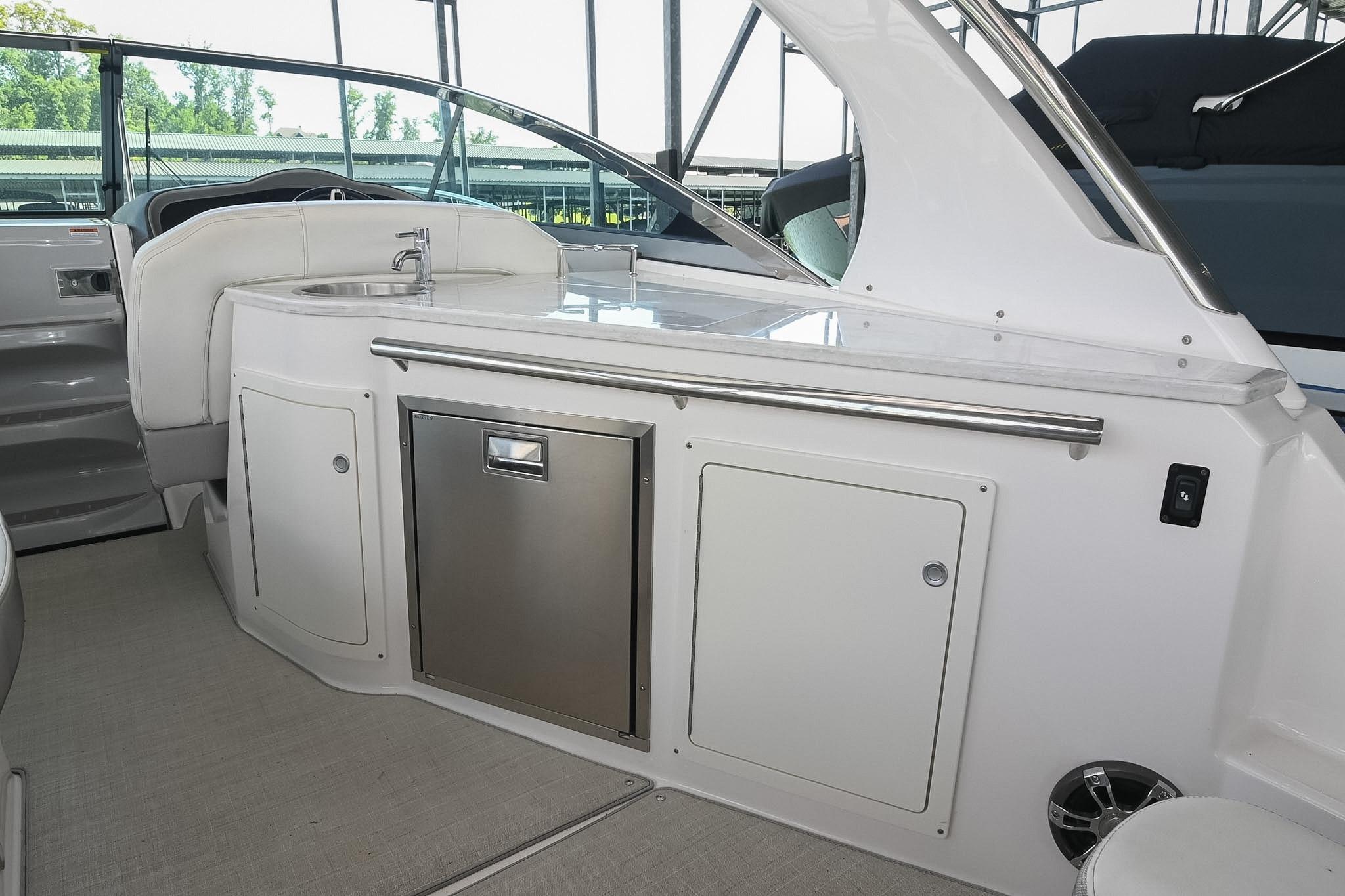 2021 Regal 33 Express boat interior with kitchenette and stainless steel fixtures.