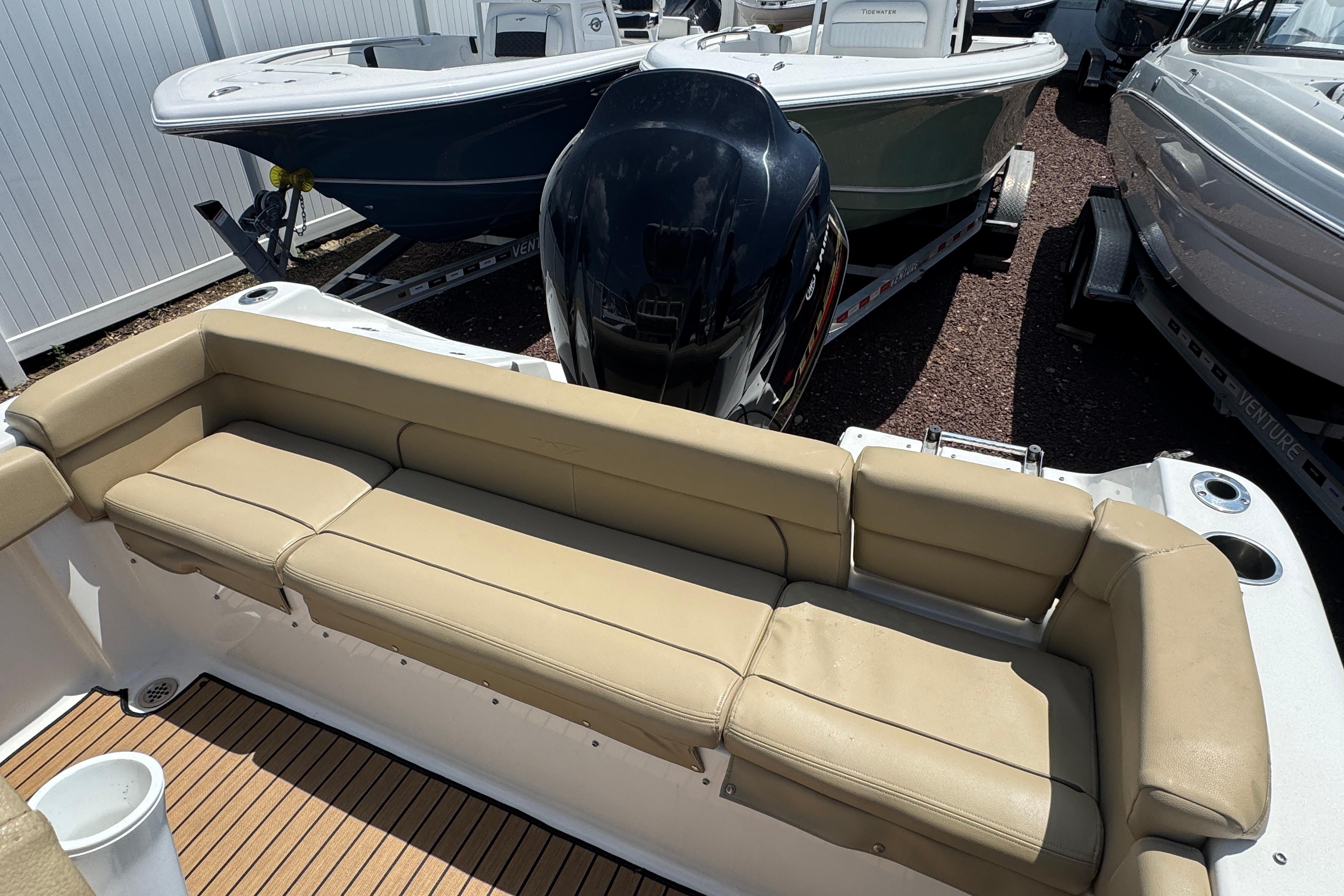2016 Tidewater 230 LXF boat interior with tan seating and outboard motor.