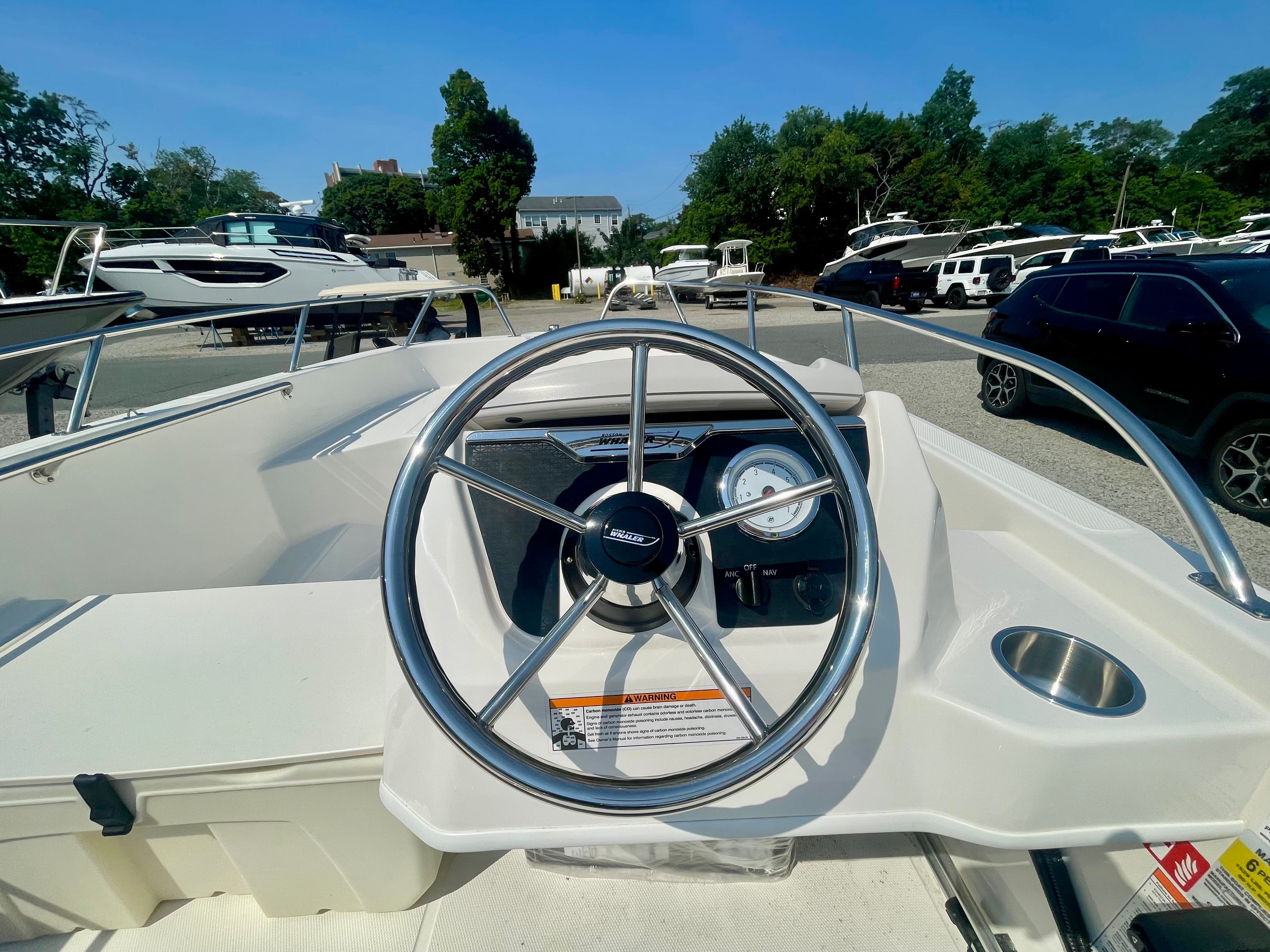 The image shows the helm of a 2026 Boston Whaler 160 Super Sport boat.
