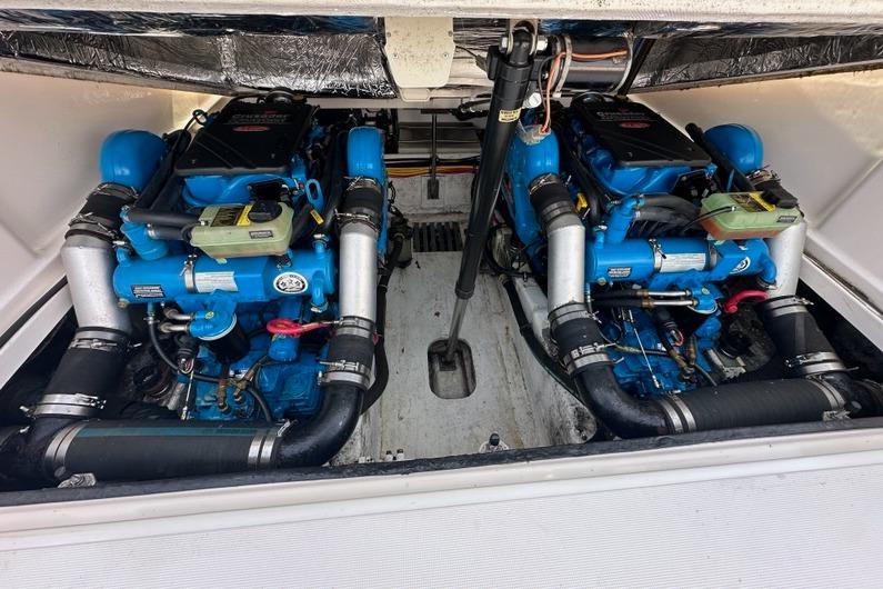 Engine compartment of a 2006 Tiara Yachts 2900 Coronet, featuring dual blue engines.
