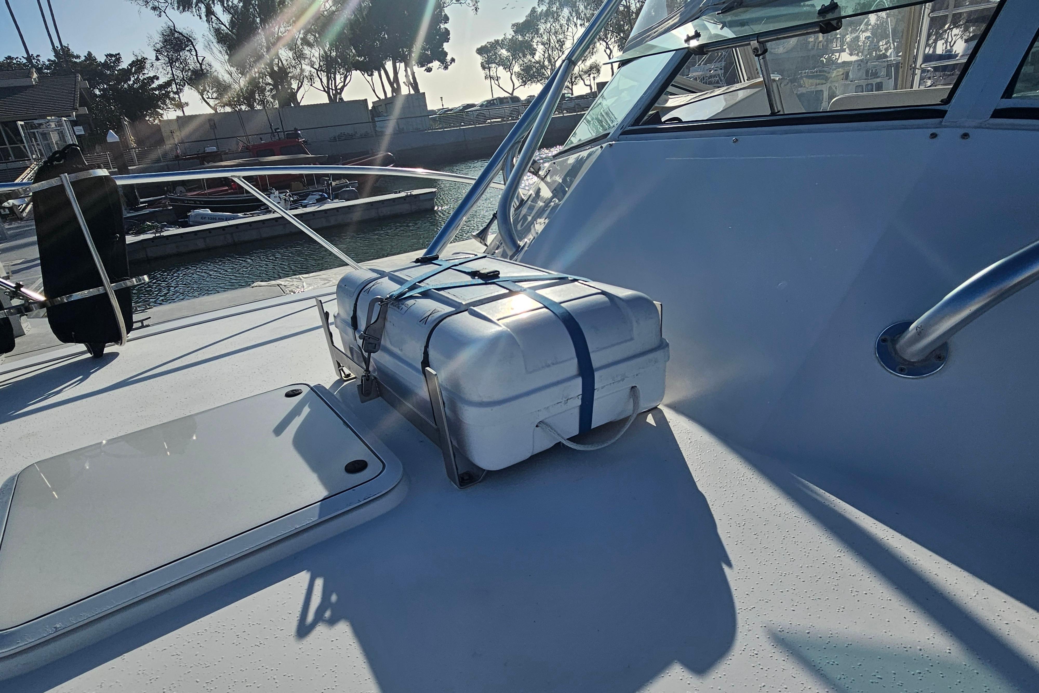 2003 Topaz 32 Express boat deck with secured white storage box.