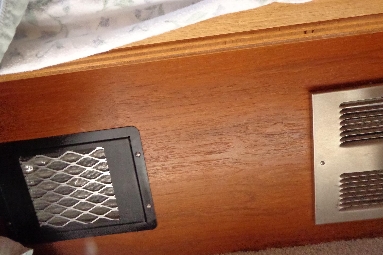 Wooden interior panel with metal vents in a 1992 Cruise-A-Home Corsair 4200.