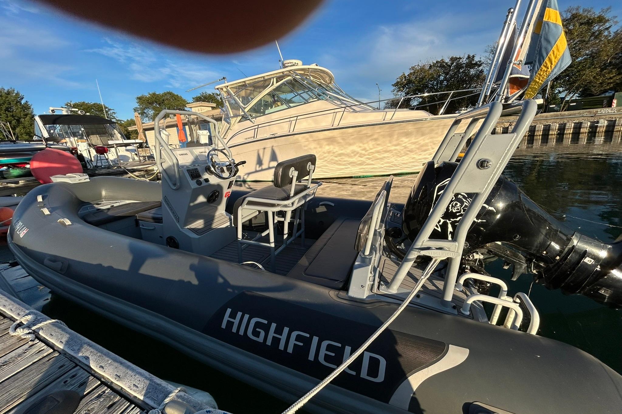 Highfield inflatable boat docked near 2007 Grady-White Express 360 yacht on a sunny day.