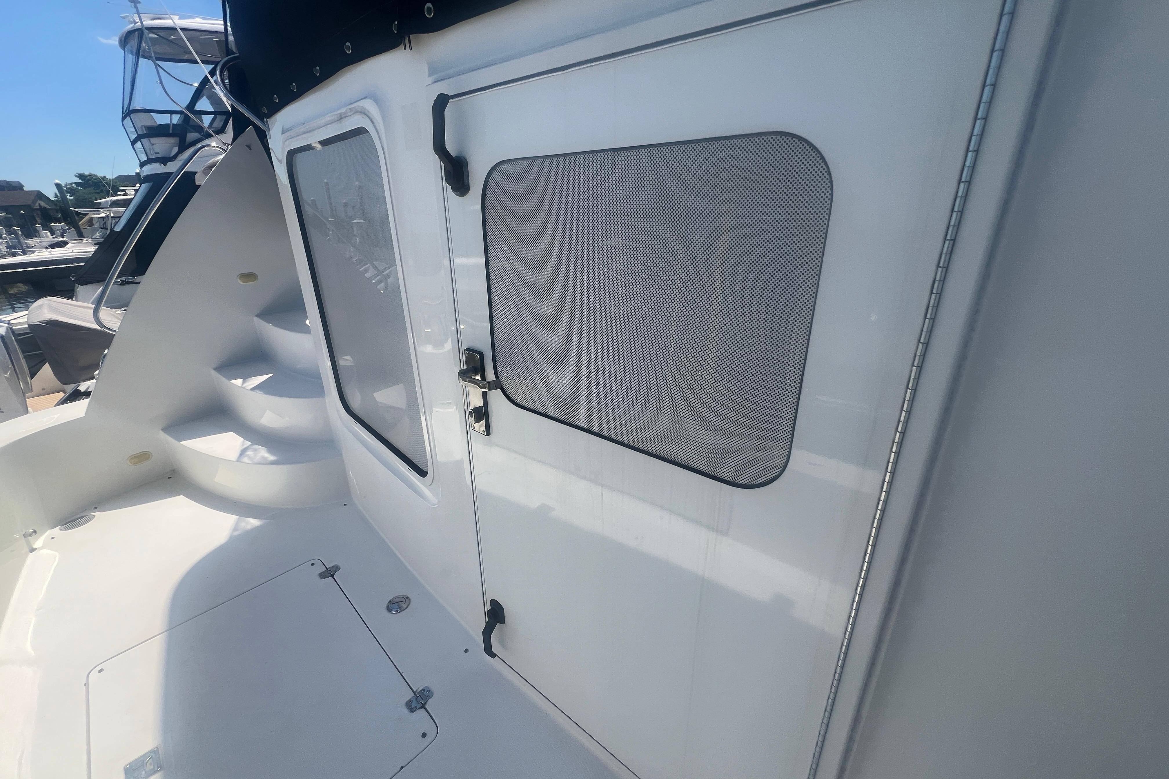 2006 Carver 43 Motor Yacht exterior with door and stairs, docked at marina.