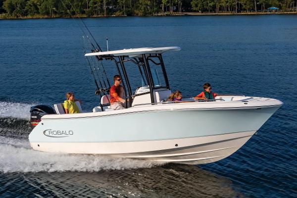Manufacturer Provided Image: 2025 Robalo R232 Explorer boat cruising on a serene lake with passengers onboard.